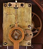 E. Howard & Co., Boston, Mass., "No. 5 Regulator", banjo clock, rosewood grained cherry case with reverse painted throat and box glass, signed Roman numeral white painted dial, 8 day timepiece movement, damascened pendulum with wooden rod, inside of case with Daniel Pratt & Son repair label, together with a photograph of the clock hanging in a Hanson or Woods Hole, Mass. railroad station office.