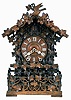 Johann Baptist Beha, Eisenbach, model 512 shelf cuckoo, nicely carved case with rustic railings covered in vines, roof with individually carved shakes and also trimmed with rustic ornament, vines, and a carved bird, Roman numeral wooden dial, pierced and carved bone hands, full body carved and painted cuckoo, 8 day, time and strike fusee movement with wooden plates, case back with the label of Camerer, Cuss & Co.