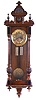 Gustav Becker, Freiburg, Germany, walnut case with turned and carved ornament, Arabic numeral, engraved brass dial, blued steel hands, 8 day time and strike movement, engraved brass pendulum and weights