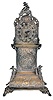 Desk clock in miniature tall clock form, silver case with bombe base and arch top, decorated with rococo style, repousse ornament, and with three cast putti, containing a thirty hour, continental verge fusee watch movement, 19th century