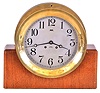 Chelsea Clock Co., Boston, Mass., 8 inch ships bell clock with custom made mahogany stand, cast brass case, Arabic numeral silvered dial, steel moon hands, 8 day lever movement with ships bell striking, serial No. 527160