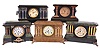 Clocks- 5 (Five): Mixed lot of four Seth Thomas Clock Co., 8 day, time and strike spring brass movement mantel clocks in Adamantine cases and one Sessions Clock Co., 8 day, time and strike spring brass movement black enameled wood mantel clock, c1910