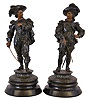 Two cast spelter figures on ebonized wooden bases, probably representing Don Caesar and Don Juan, or two of the musketeers