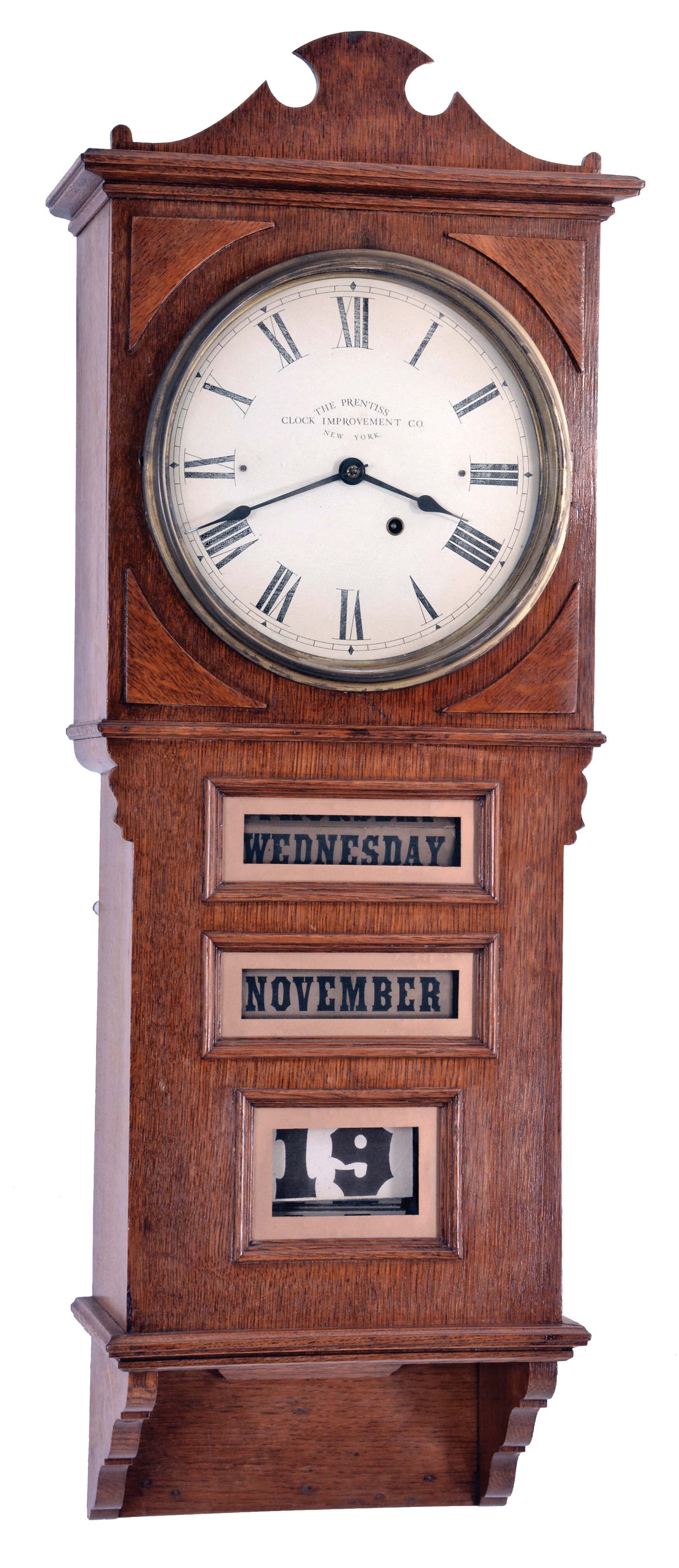 The Prentiss Improvement Clock Co., 49 Dey Street, New York, New York, "Empire" wall clock with an 8 day time only Seth Thomas movement and a Prentiss patented calendar mechanism in an oak veneered case. — Antique Clocks Price Guide