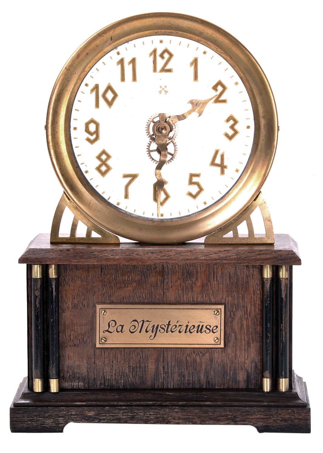 German, Hamburg - American Clock Co., "La Mysterieuse" desk or table clock, rectangular oak base supporting the Arabic numeral transparent dial with brass bezel, movement contained in the base, and driving a second invisible disc to which the motion work is attached, thus driving the hands — Antique Clocks Price Guide