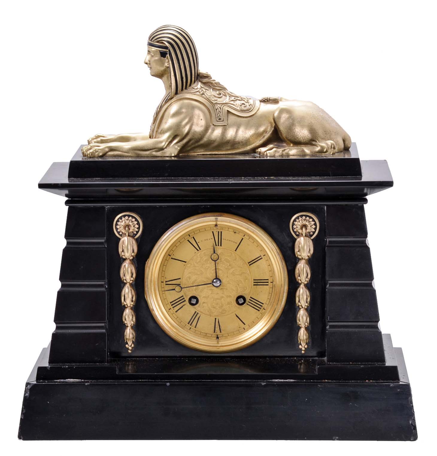 Jean-Baptiste Delettrez (J.B.D.), Paris, for W.C. Shaw, Glasgow, mantel clock, 8 day, time and strike, spring driven movement with unusual key setting arbor in the lower front of the dial, black slate Egyptian revival case with gilt dial and accents, the whole surmounted by a gilt sphinx figure. — Antique Clocks Price Guide