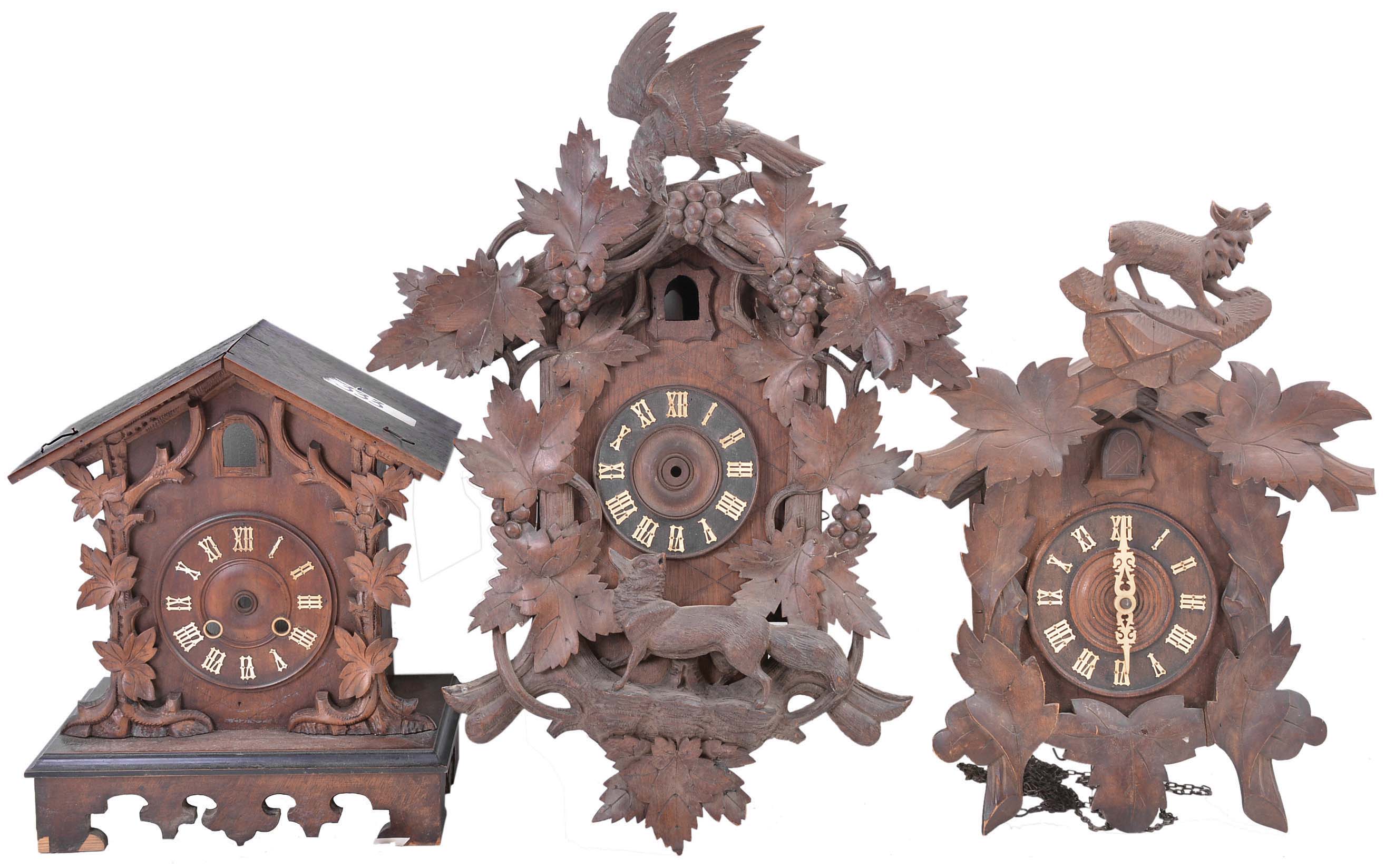 Clocks- 11 (Eleven) antique and modern cuckoo clocks for parts or repair and 2 (Two) cuckoo clock cases including a shelf cuckoo and a carved case from the American Cuckoo Clock Co. depicting the fable of the fox and the grapes. Clock weights include 4 (Four) modern sets and 1 (one) older pair. — Antique Clocks Price Guide