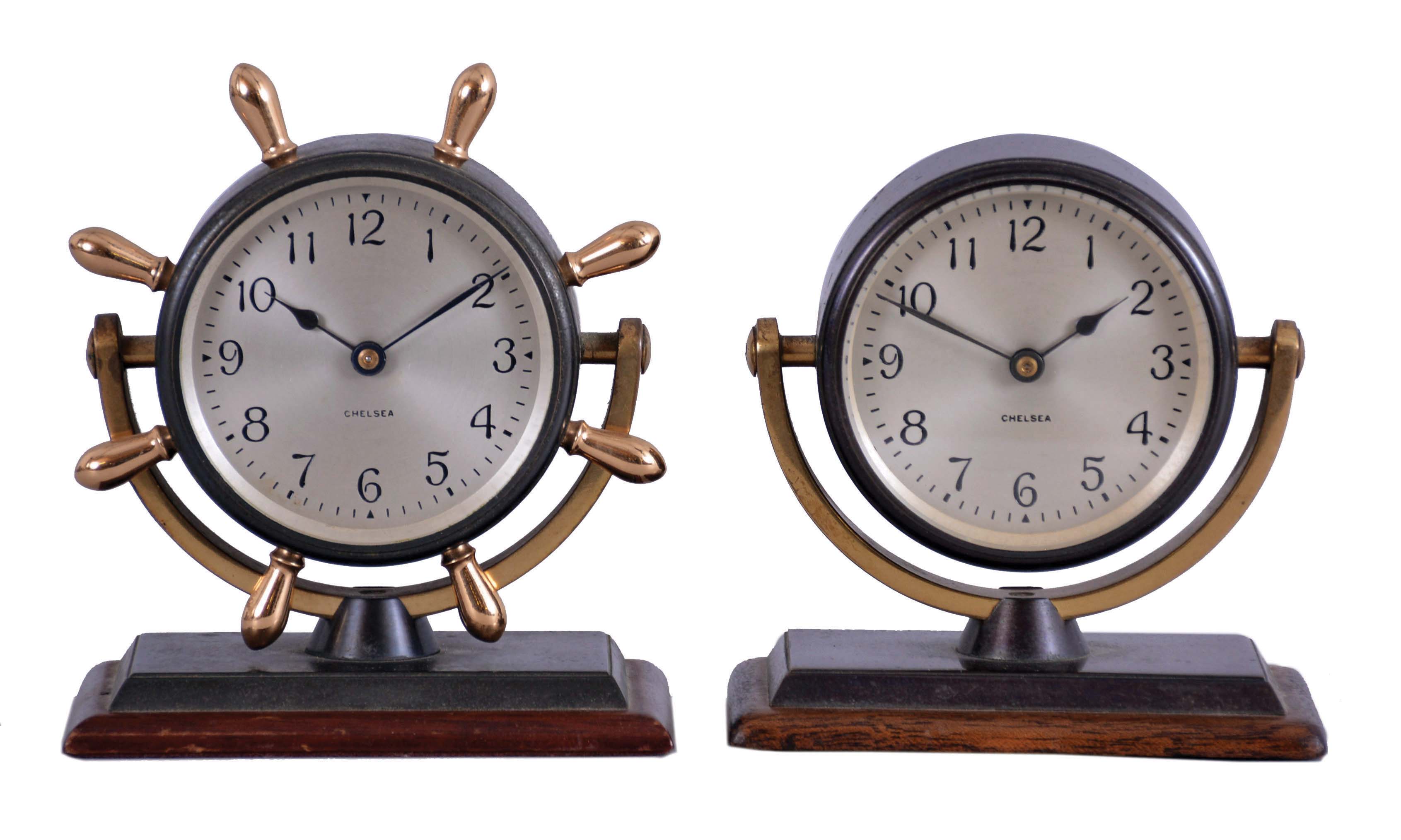 Clocks- 2 (Two) Chelsea Clock Co: (1) "Comet", 8 day, timepiece with 2.75 inch dial in a bronze case with yellow brass cradle and spokes mounted to a mahogany base, c1960; (2) "Haley", 8 day, timepiece with 2.75 inch dial in a bronze case with yellow brass cradle mounted to a mahogany base, c1960 — Antique Clocks Price Guide