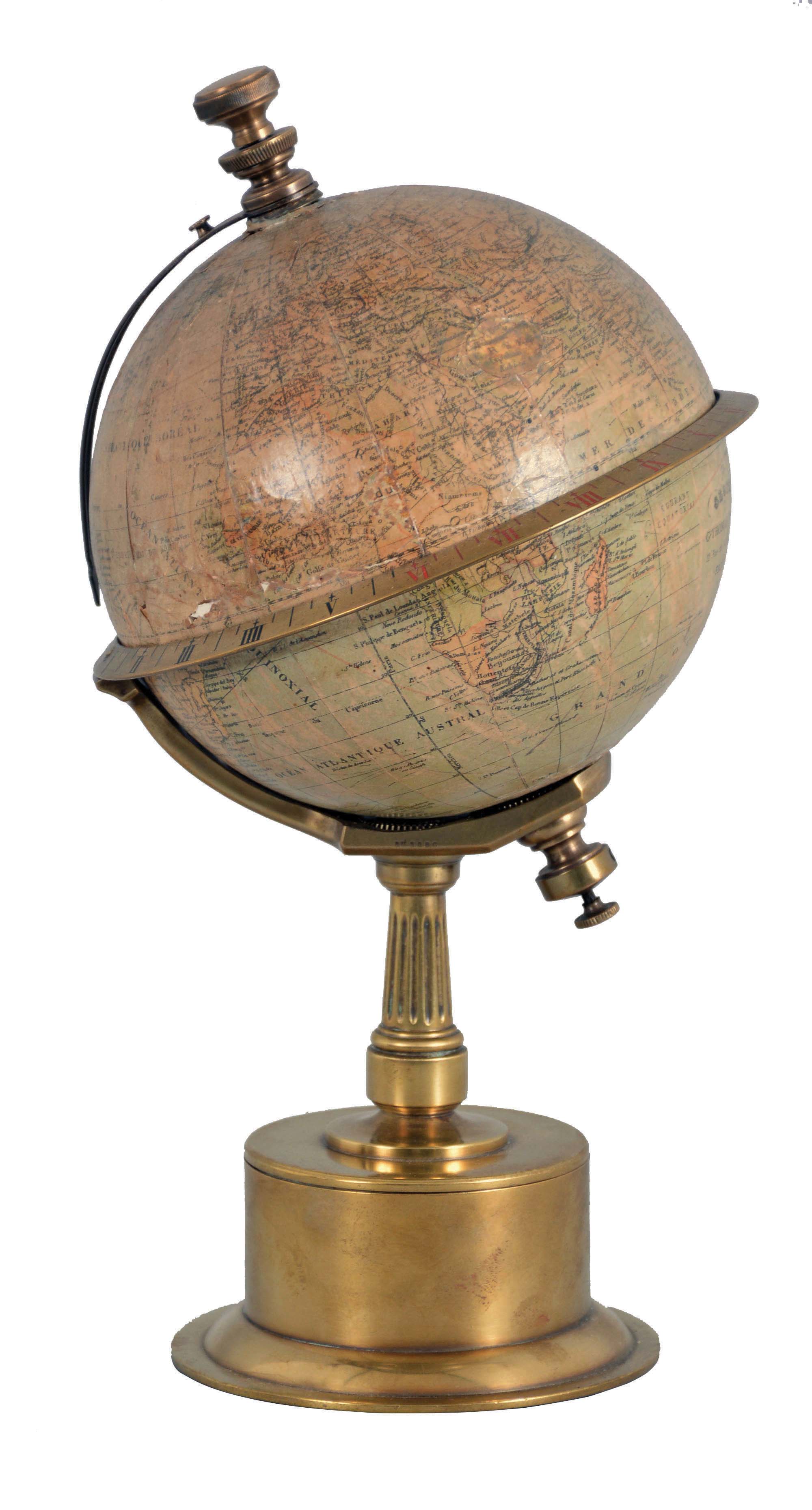 G. Thomas, Editeur, 11 Rue de Sommerard, Paris, an Edwardian globe clock, the cylindrical, quarter round molded brass base supporting a tapered, fluted column, attached to the stationary globe mount, engraved, Roman numeral equatorial ring with adjustable pointer, and 8 day timepiece movement concealed in the base, driving the globe through the a linkage in the column, c1890. — Antique Clocks Price Guide