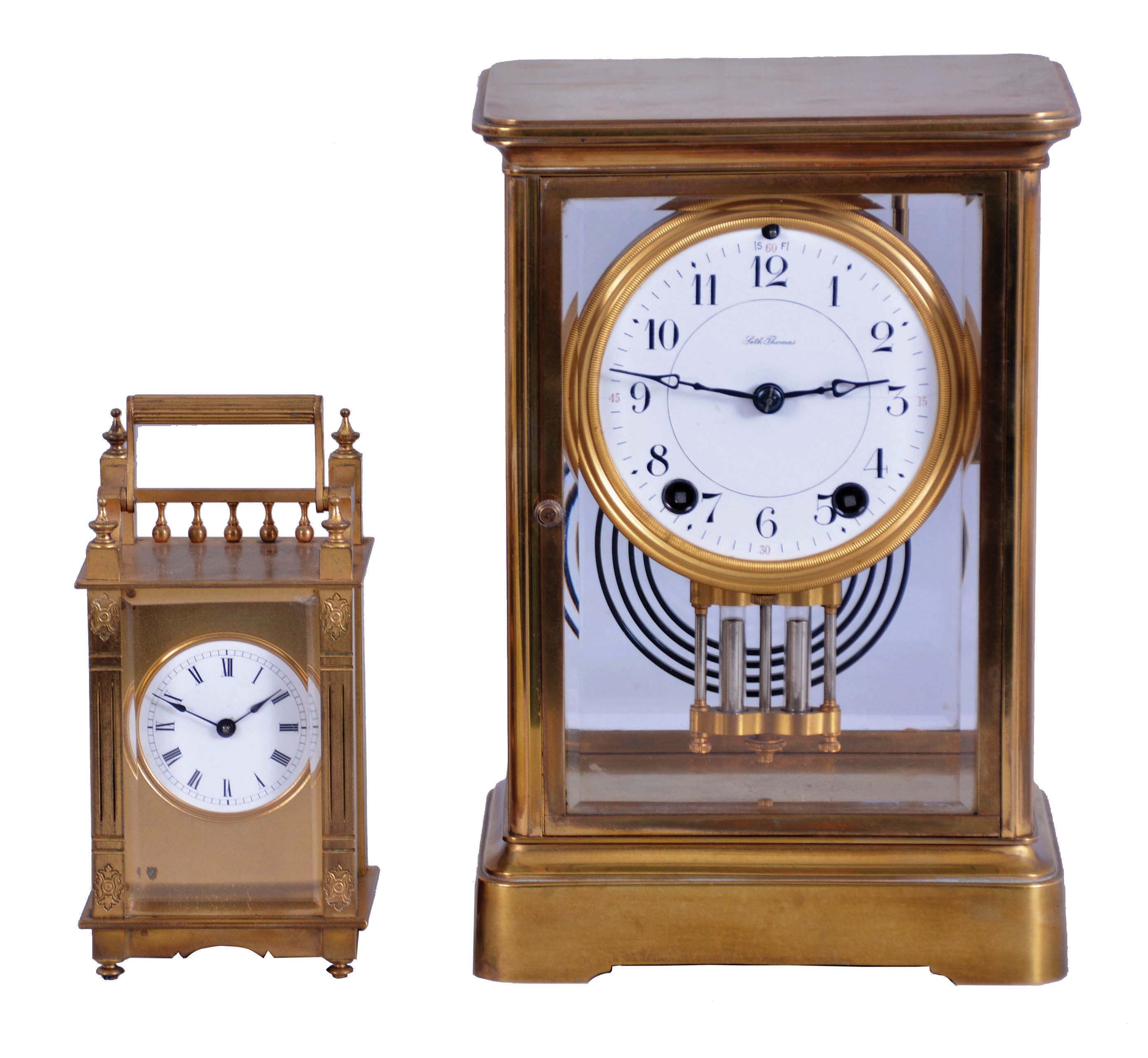 Clocks- 2 (Two) Brass &amp; Glass: (1) Seth Thomas Clock Co., Thomaston, Conn., "Empire No. 200 EXTRA" crystal regulator, 8 day, time and gong strike with round brass movement, c1921. (2) Boston Clock Co., Chelsea, Mass., "Queen Anne" carriage clock, 8 day, timepiece with platform escapement in a gilt brass case with three beveled glasses and white enamel dial showing Roman numerals. Dedicated on the back to "Jeannie", c1890. — Antique Clocks Price Guide