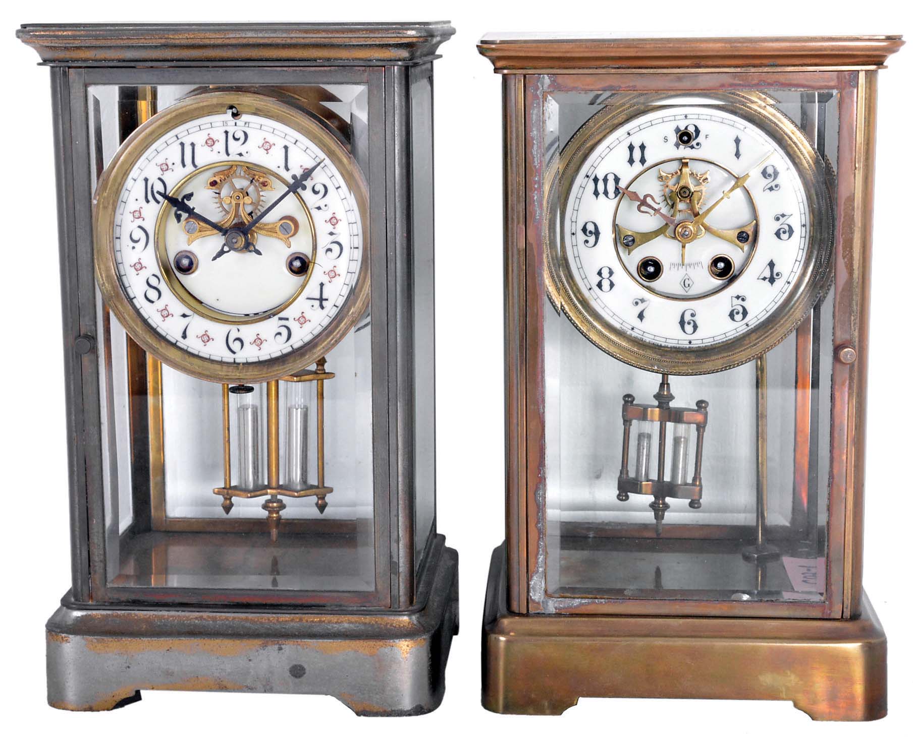 Clocks- 2 (Two) American crystal regulators: (1) William L. Gilbert Clock Co., Winsted, Conn. spring driven, 8 day, time and strike with visible escapement; (2) Unsigned, probably Waterbury Clock Co., Waterbury Conn., 8 day, time and strike, with a visible escapement. — Antique Clocks Price Guide