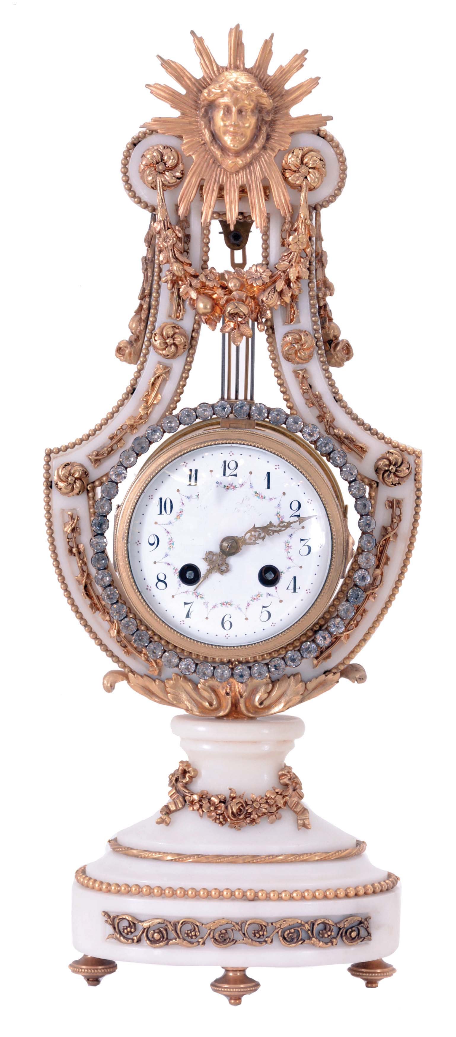 France, lyre form mantel clock, white marble case with gilt bronze mounts, including fruit and floral festoons, trailing vines and other classically inspired ornament, the top with Helios mask, knife edge pendulum, attached to an oscillating pendulum ring of brilliants, Arabic numeral white enamel dial with polychrome enamel garlands, fancy gilt hands, 8 day, time and strike pendule de Paris movement — Antique Clocks Price Guide