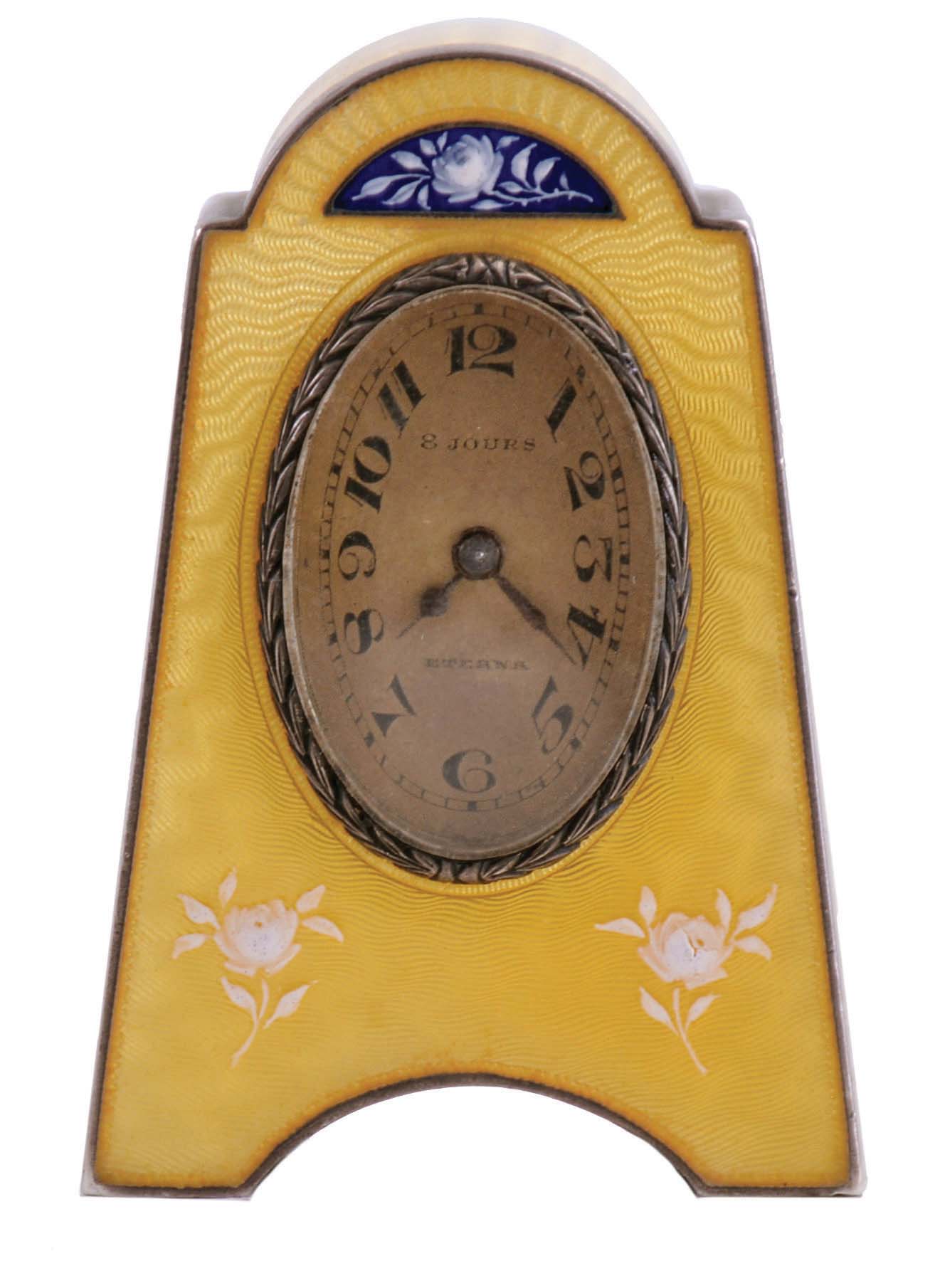 Eterna Watch Co., Switzerland, desk or bedside clock, silver gilt case with yellow guilloche enamel and floral ornament, Arabic numeral, oval silvered dial, blued steel hands, 8 day, 15 jewel timepiece movement with lever escapement — Antique Clocks Price Guide