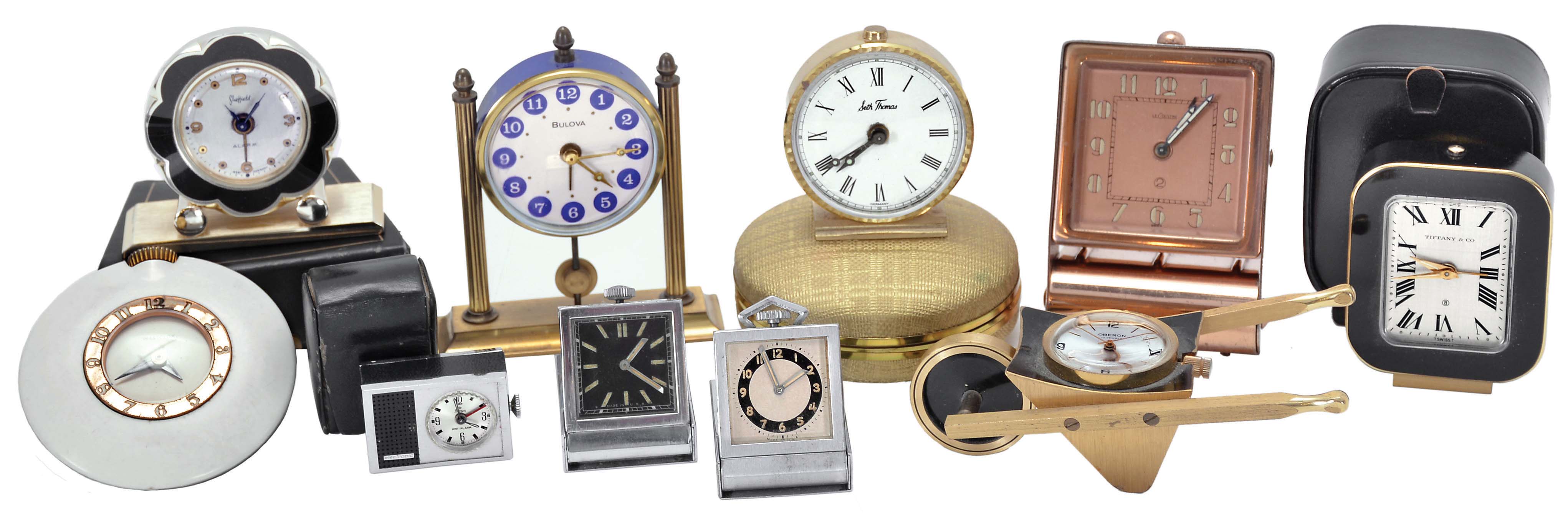 Clocks- 10 (Ten): including a "Tiffany &amp; Co." travel alarm with outer case, an "Oberon" with wheelbarrow form case, a "LeCoultre" travel alarm with folding case, a "Sheffield" travel alarm with outer case, a "Stowa" travel alarm with outer case, two folding purse watches, and others — Antique Clocks Price Guide