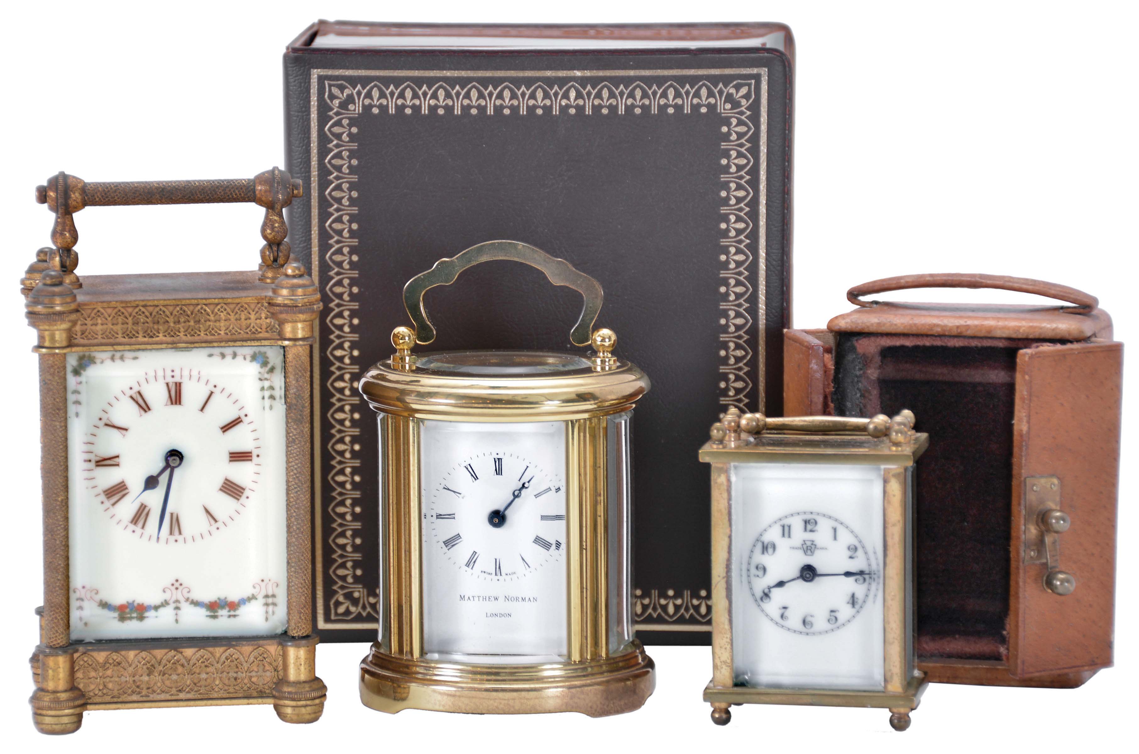 Carriage clocks- 3 (Three): including a "Matthew Norman" with oval case and original outer box, another with gilt case and decorative white enamel dial, and a Waterbury miniature with outer case — Antique Clocks Price Guide
