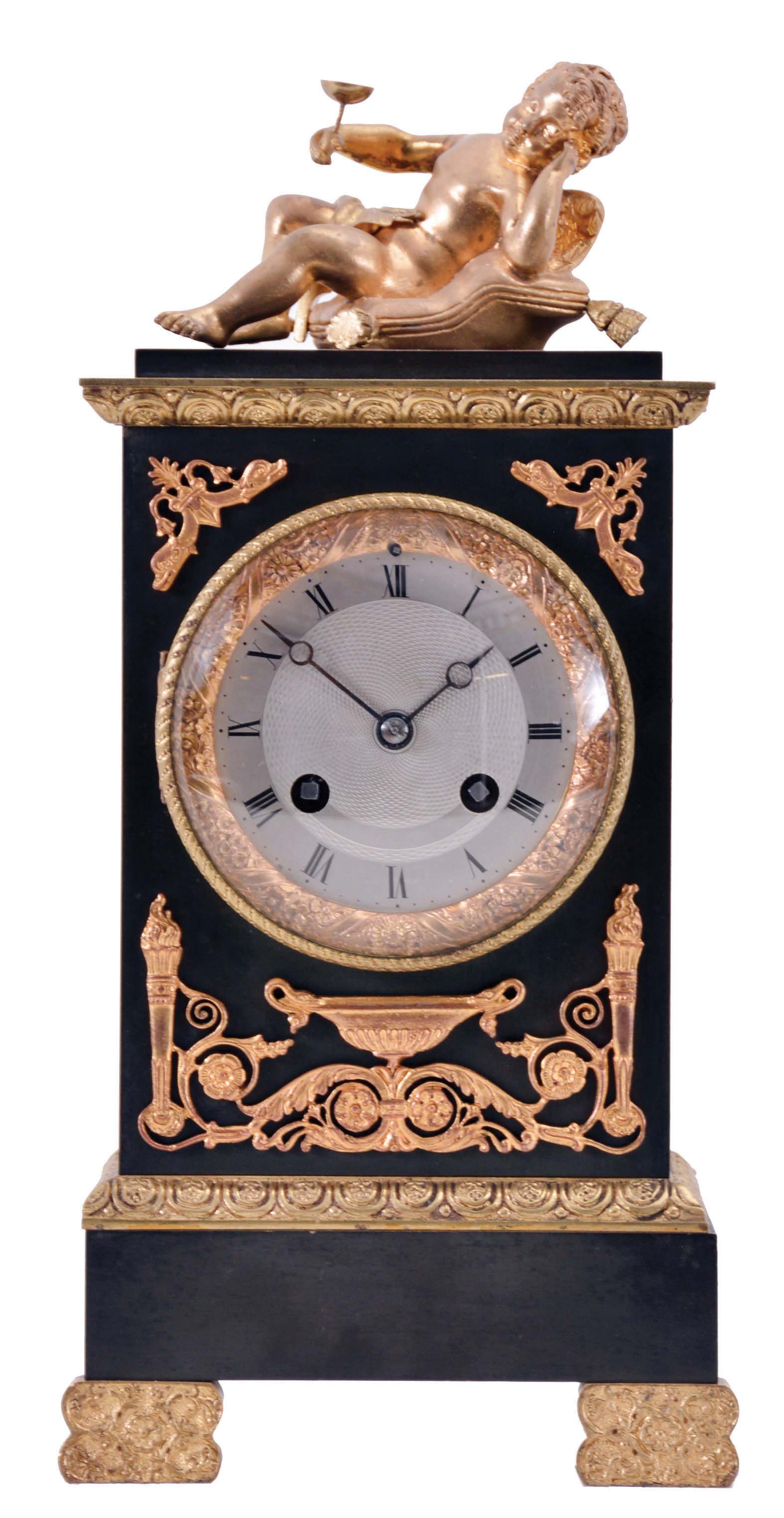 France, a small gilt and patinated bronze mantel clock in the Empire style, case with green patination and gilt mounts, surmounted by a reclining putto, Roman numeral, engine turned, silvered dial, blued steel Breguet style hands, 8 day, time and strike, pendule de Paris movement, signed Marti — Antique Clocks Price Guide
