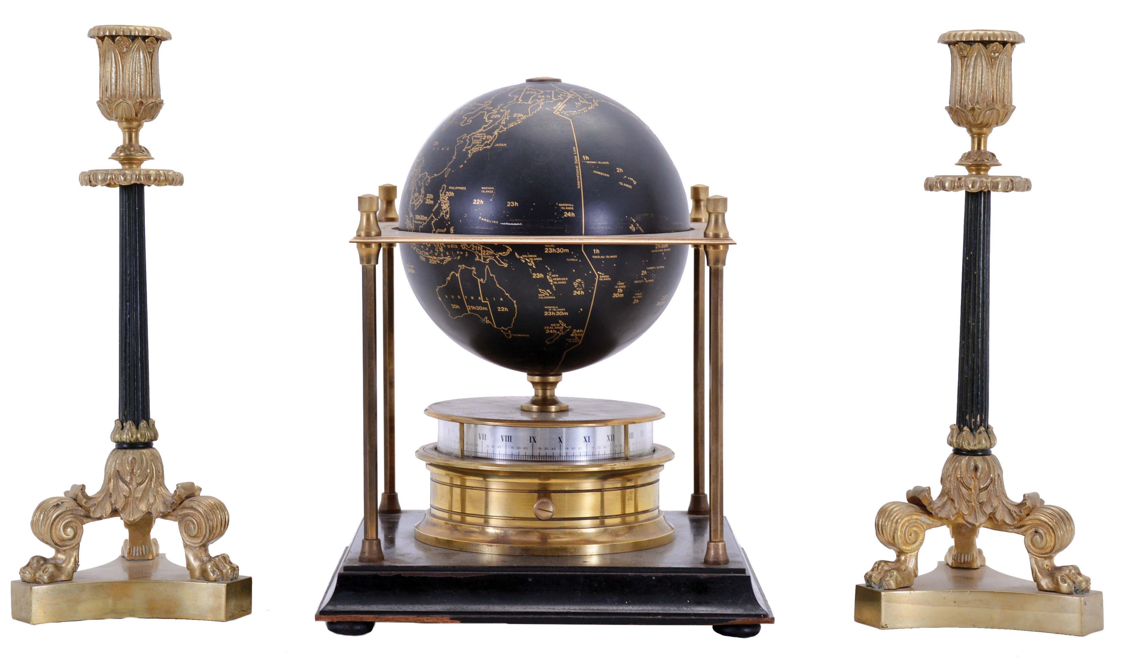 Franklin Mint/ Royal Geographical Society globe clock, ebonized base with slender columns at corners supporting an equatorial plate, turned brass clock case with annular dial supporting a terrestrial globe, 8 day Imhof movement, together with a pair of Empire style candlesticks with tripod bases, clock dimensions listed — Antique Clocks Price Guide