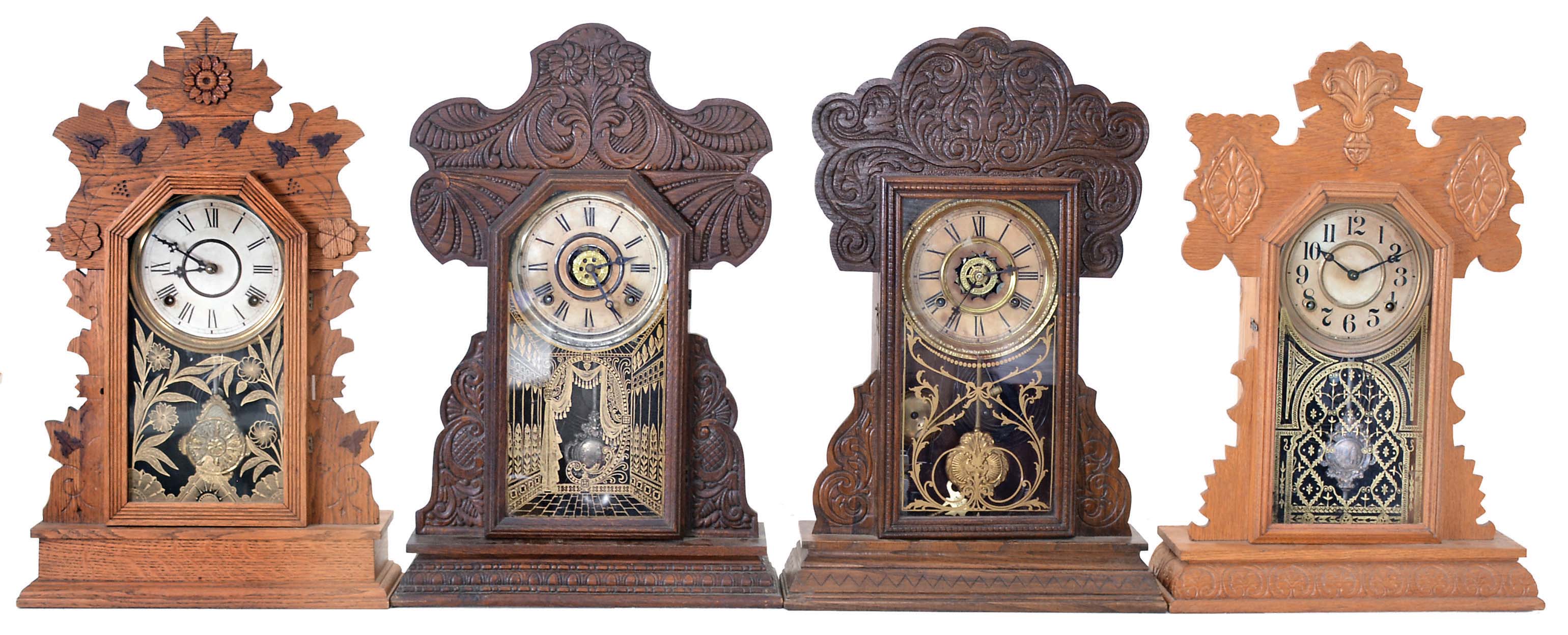 Clocks- 4 (Four): (1) E. Ingraham &amp; Co., Bristol, Conn., unidentified model shelf clock with a spring driven, 8 day, time and strike movement in an oak case, c1895; (2) Wm. L. Gilbert Clock Co., Winsted, Conn., "Dove" shelf clock with a spring driven, 8 day, time and strike movement in an oak case, c1900; (3) The E. Ingraham &amp; Co., Bristol, Conn., unidentified model shelf clock with a spring driven, 8 day, time and strike movement in a oak case, c1915; (4) Waterbury Clock Co., Waterbury, Conn., "Henshaw" shelf clock with a spring driven, 8 day time, strike and alarm movement in an oak case, c1906. — Antique Clocks Price Guide