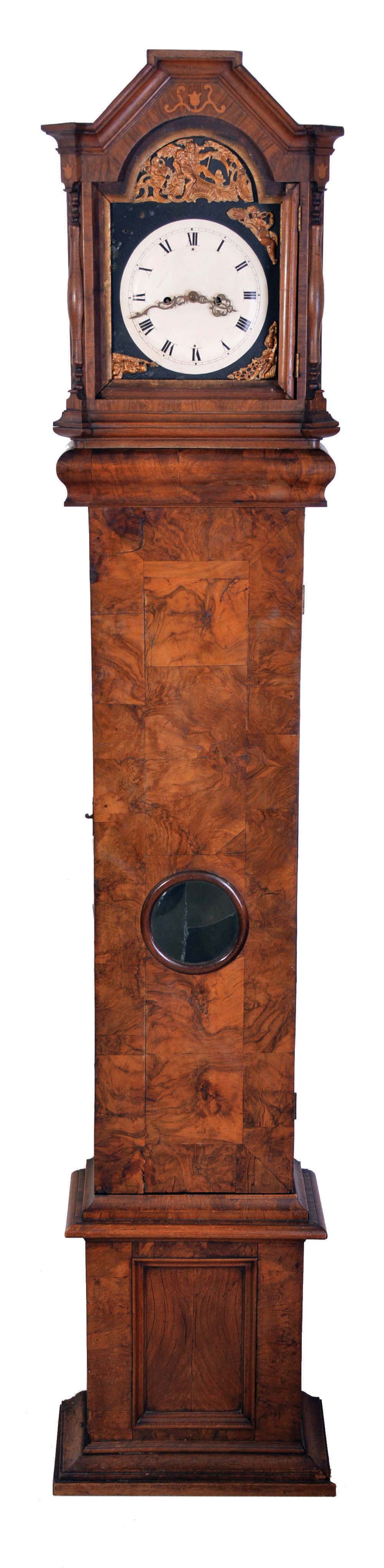 Tall Clocks- 3 (Three): The first, a late 19th century pinwheel regulator, oak case with round top and removable crest, sides with applied scroll ornament, Roman numeral white enamel dial, blued steel hands, 8 day weight driven timepiece movement with heavy gridiron pendulum, the next an 18th century European tall clock with walnut veneer case, molded and paneled base below trunk door with glazed oculus, bonnet with canted corners, 8 day, time and strike movement, and sheet iron dial with applied chapter ring, the last by T. Gate, Carlisle, oak case with flat top bonnet, brass composite dial, and 8 day, time and strike movement, together with a nickel plated regulator pendulum, — Antique Clocks Price Guide