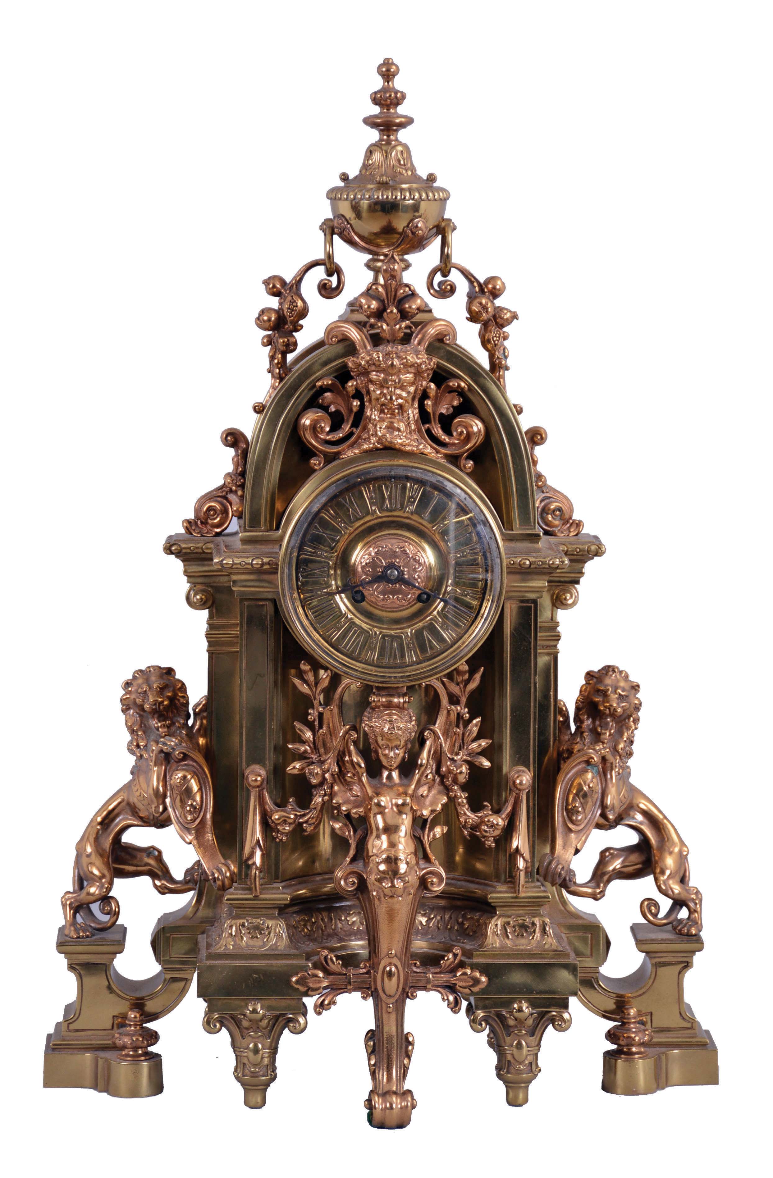 France, a large and imposing cast brass and bronze mantel clock, the base on tapered, scroll and cartouche ornamented feet, case front with niche containing a winged, half caryatid terminating in a foliate scroll, the sides with lions rampant guardant on pedestals, the top with bearded mask surrounded by foliate ornament and surmounted by an urn finial with flanking botanical pendants, Roman numeral dial with ornamental center, blued steel hands, 8 day, time and strike, pendule de Paris movement — Antique Clocks Price Guide