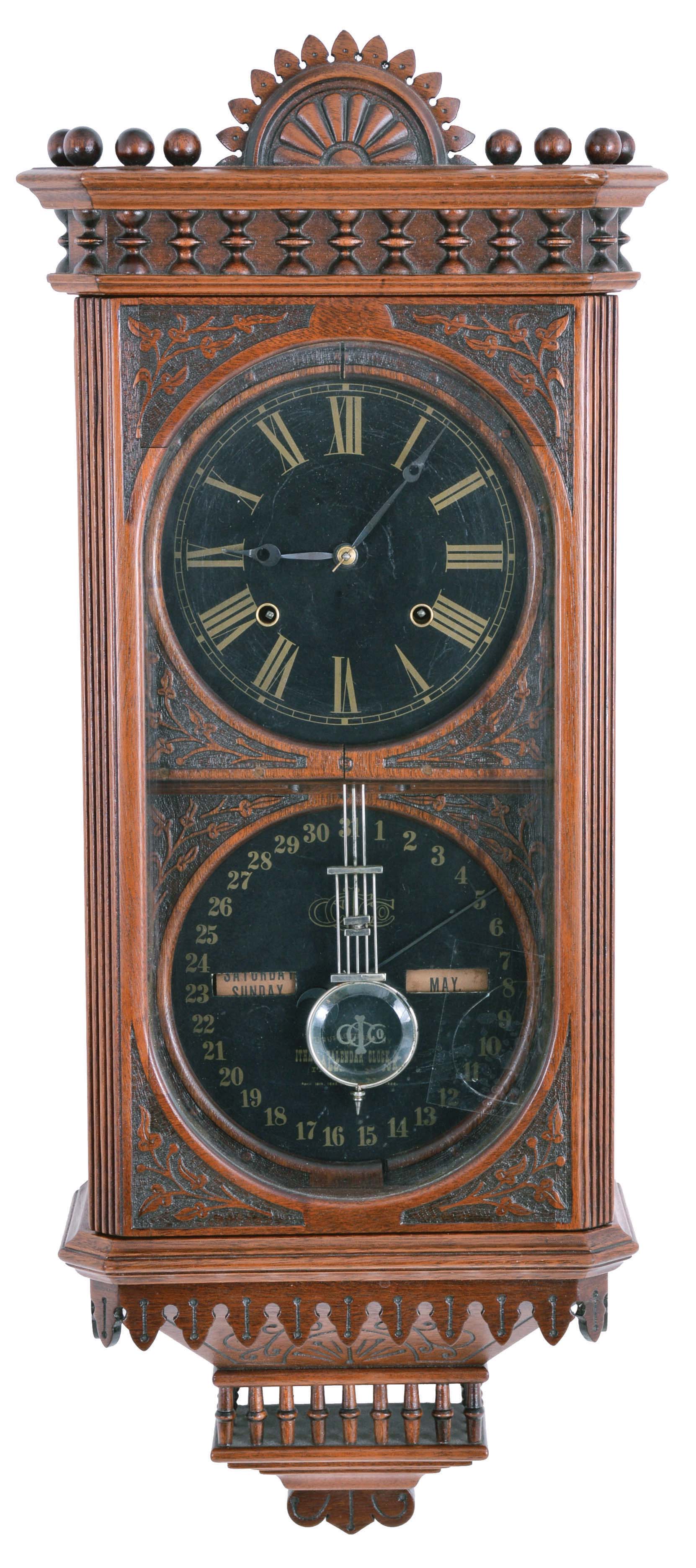 Reproduction Ithaca Calendar Clock Co., "Hanging Kildare" wall clock, 8 day, time and strike, spring driven movement with perpetual calendar, in a walnut case with black papered dials and cut crystal pendulum — Antique Clocks Price Guide