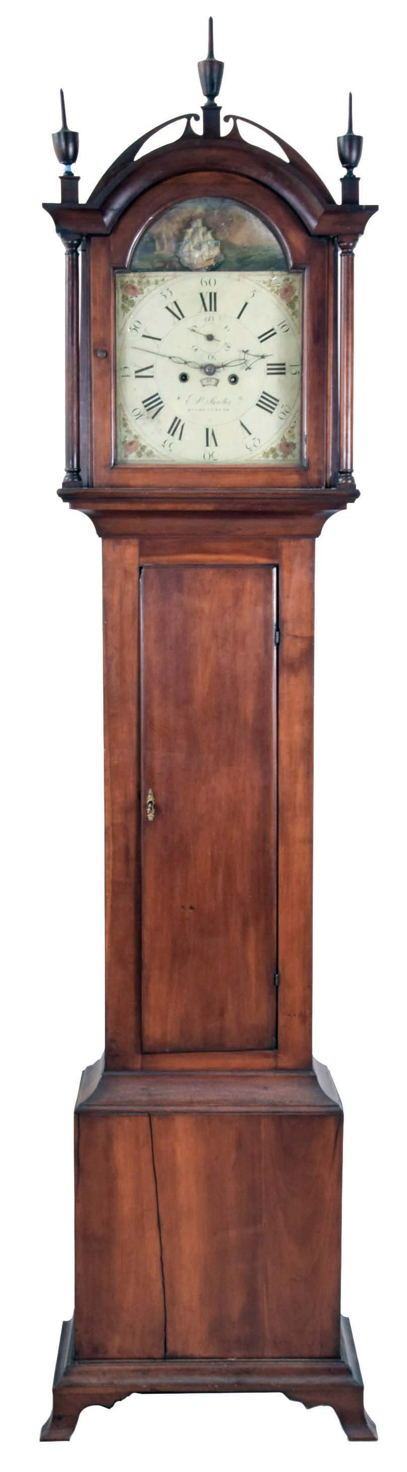 Edward S. Moulton, Rochester, New Hampshire tall case clock, the cherry case with fretwork top, turned finials and ogee bracket feet, numbered and signed by the maker, Roman numeral painted metal dial with seconds bit, calendar, and rocking ship, the back with label of Spencer &amp; Nolen, Washington St., Boston, 8 day, time and strike, brass weight driven movement — Antique Clocks Price Guide