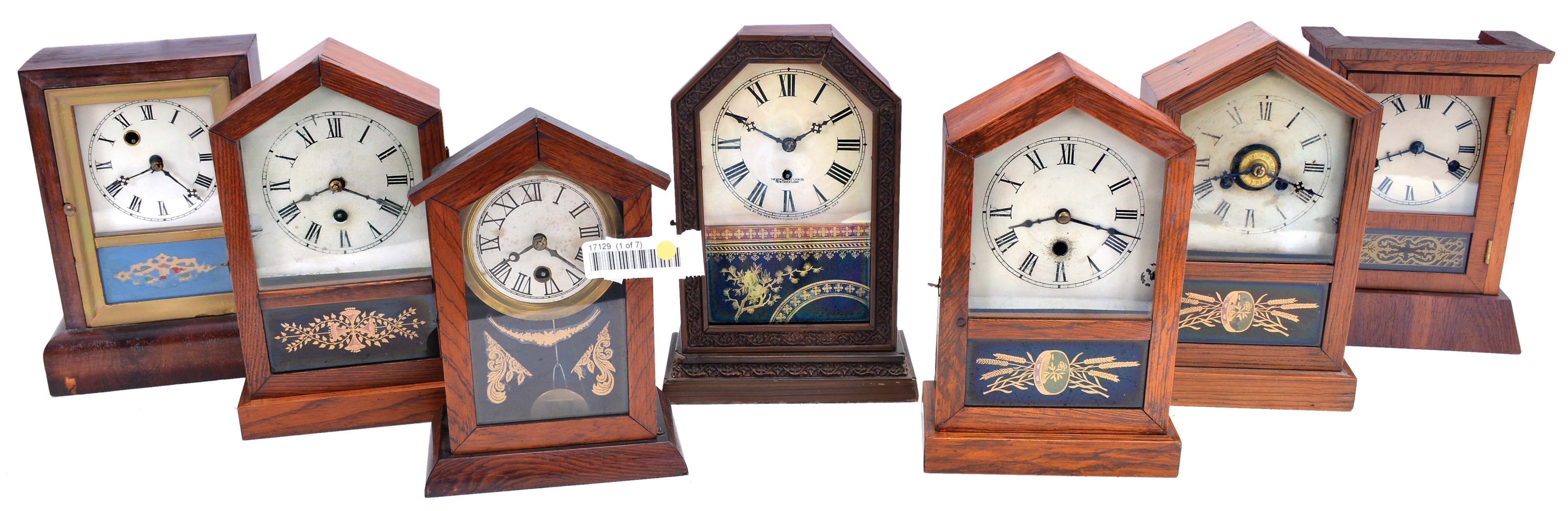 Clocks- 7 (Seven): (1) Waterbury Clock Co., Waterbury, Conn., Cottage shelf clock with a spring driven 30 hour timepiece movement in a rosewood veneered case, c1870; (2) Jerome &amp; Co., New Haven, Conn., "Rocket" shelf clock with a spring driven 30 hour timepiece movement in an oak case, c1870; (3) Unidentified cottage shelf clock (likely German) with a spring driven 30 hour timepiece movement, c1870; (4) New Haven Clock Co., New Haven, Conn., cottage shelf clock with a spring driven 30 hour timepiece movement in a grained wood case, c1870; (5) Jerome &amp; Co., New Haven, Conn., "Rocket" shelf clock - case only; (6) Jerome &amp; Co., New Haven, Conn., "rocket" shelf clock with a spring driven 30 hour time and alarm movement in a grain painted case, c1870; (7) Seth Thomas Clock Co., Thomaston, Conn., "Anchor" shelf clock with a spring driven 30 hour time and strike movement in a rosewood veneered case, c1870. — Antique Clocks Price Guide