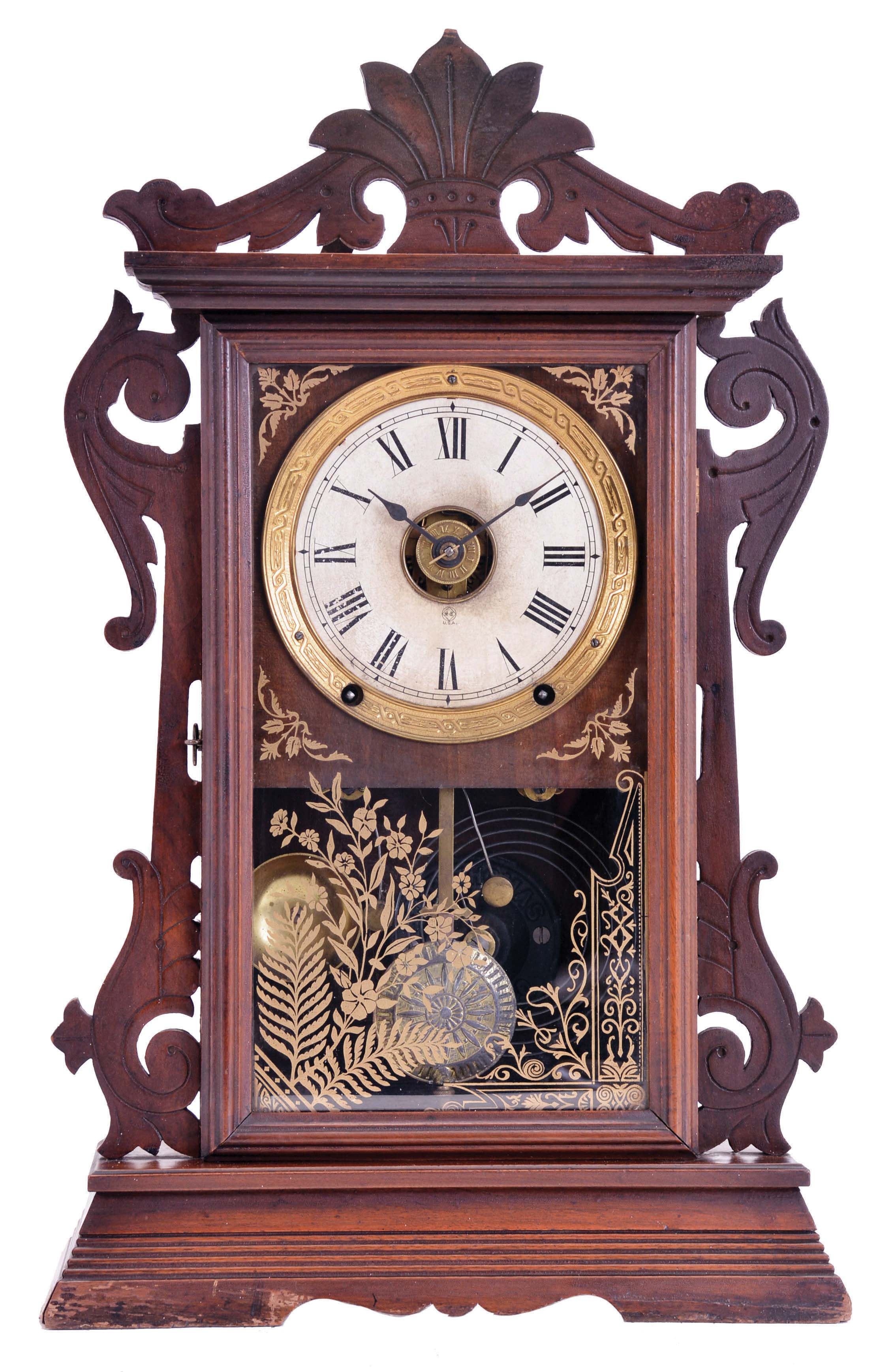 Seth Thomas Clock Co., Thomaston, Conn., "Newark" shelf clock with a spring driven, 8 day time, strike and alarm movement with a patent (British) Winward's Alarm mechanism in a walnut case. — Antique Clocks Price Guide