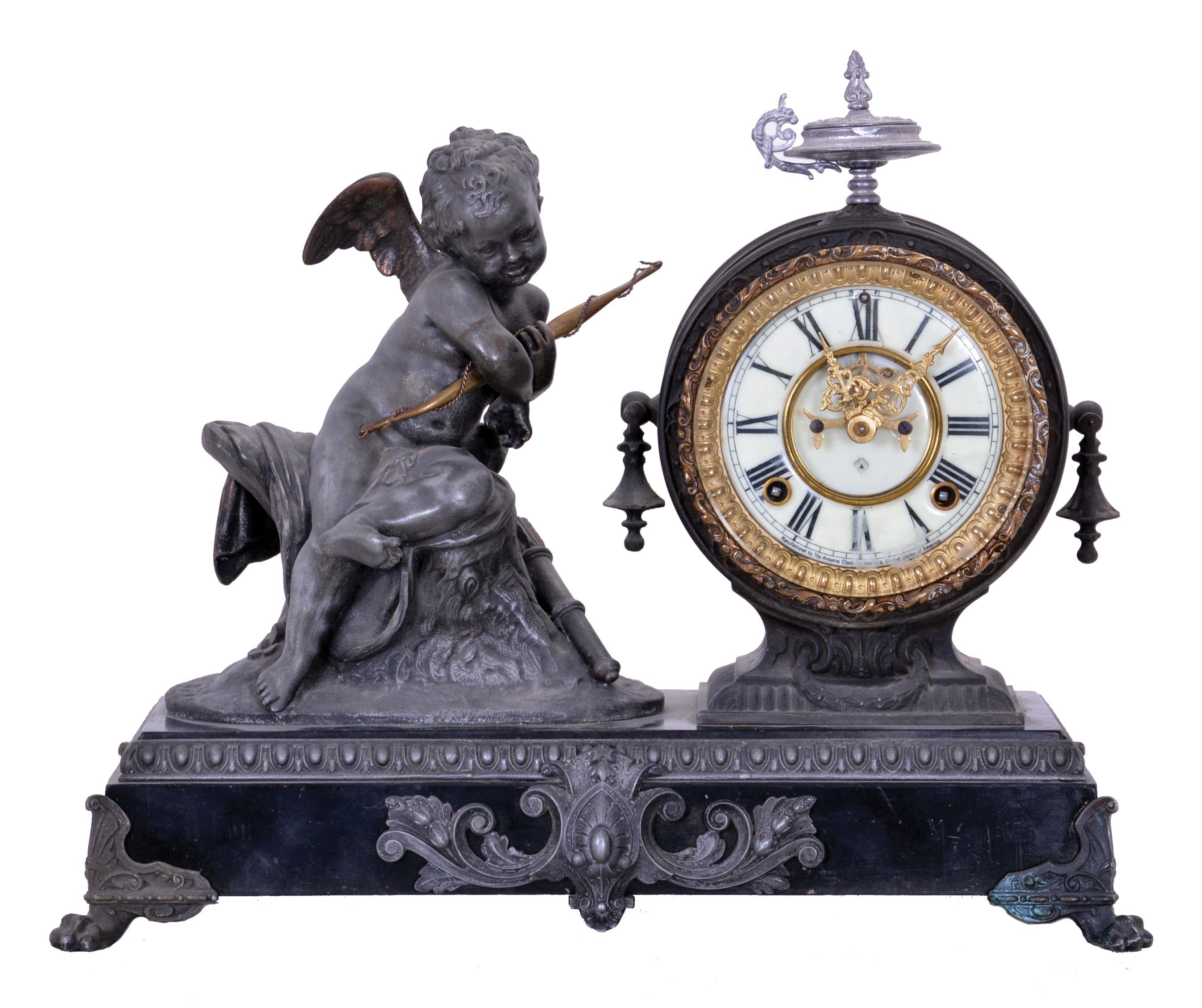Ansonia Clock Co., New York, NY, "Cupid" figural mantel clock with an 8 day spring driven time and half hour strike movement with visible escapement in a cast metal case. — Antique Clocks Price Guide
