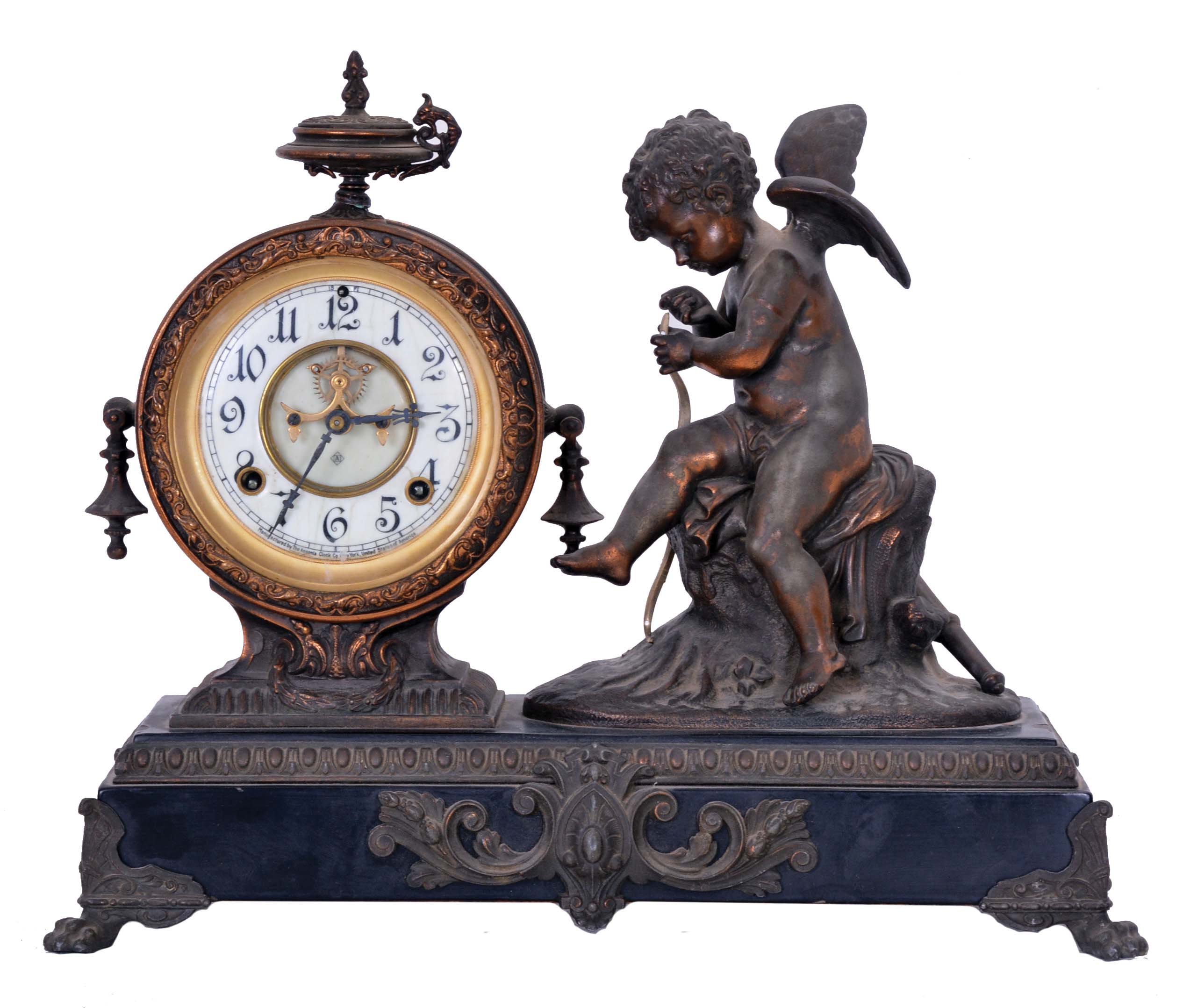 Ansonia Clock Co., New York, NY, "Eros" figure mantel clock with an 8 day spring driven time and half hour strike movement in a cast metal case with bronze plating. — Antique Clocks Price Guide