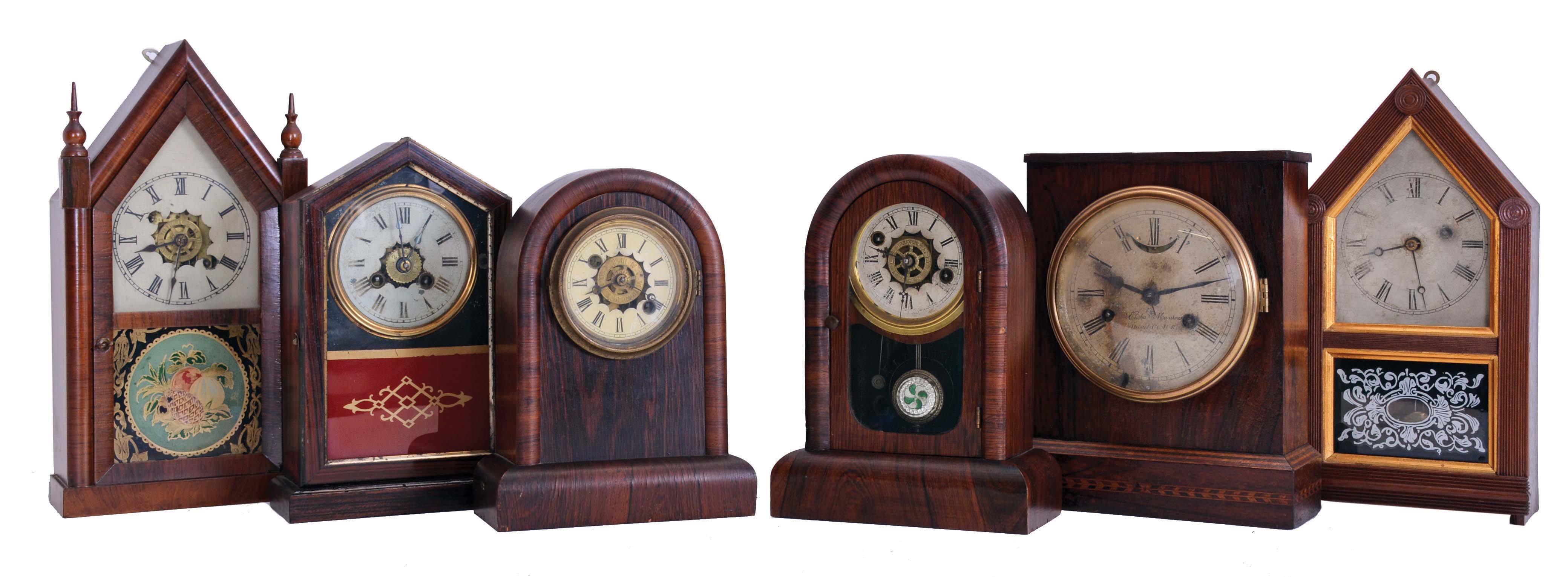Clocks- 6 (Six): (1) Jerome &amp; Co., New Haven, Conn., 30 hour, time and alarm spring driven movement miniature steeple clock, c1865; (2) Atkins Clock Co., Bristol, Conn., 30 hour, spring driven movement steeple form cottage timepiece, c1865; (3) William L. Gilbert Clock Co., Winsted, Conn., 30 hour time and alarm spring driven movement cottage timepiece, c1870; (4) William L. Gilbert Clock Co., Winsted, Conn., 30 hour, time and alarm cottage timepiece, c1870; (5) Elisha Manross, Bristol, Conn., 30 hour, time and strike spring driven, lever movement cottage clock, c1850; (6) Union Clock Co., 30 hour, time and strike spring driven movement cottage clock, c1870. Also included are two modern made clock shelves. — Antique Clocks Price Guide