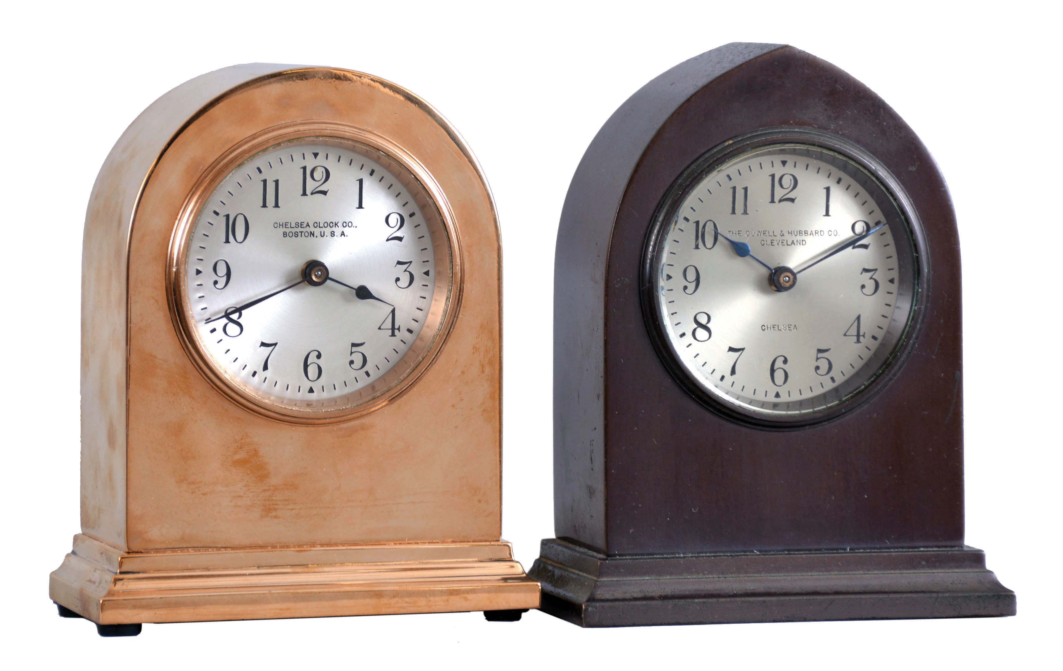 Clocks- 2 (Two) Chelsea: (1) Chelsea Clock Co., Boston, Mass., for The Cowell &amp; Hubbard Co., Cleveland, "Doric", 8 day, timepiece with 2.5 inch silvered dial in a polished red brass case, serial number 160482, c1924.; (2) Chelsea Clock Co., Boston, Mass., "Gothic", 8 day, timepiece with 2.5 inch silvered dial in a brass case with bronze finish, serial number 160078, c1924. — Antique Clocks Price Guide
