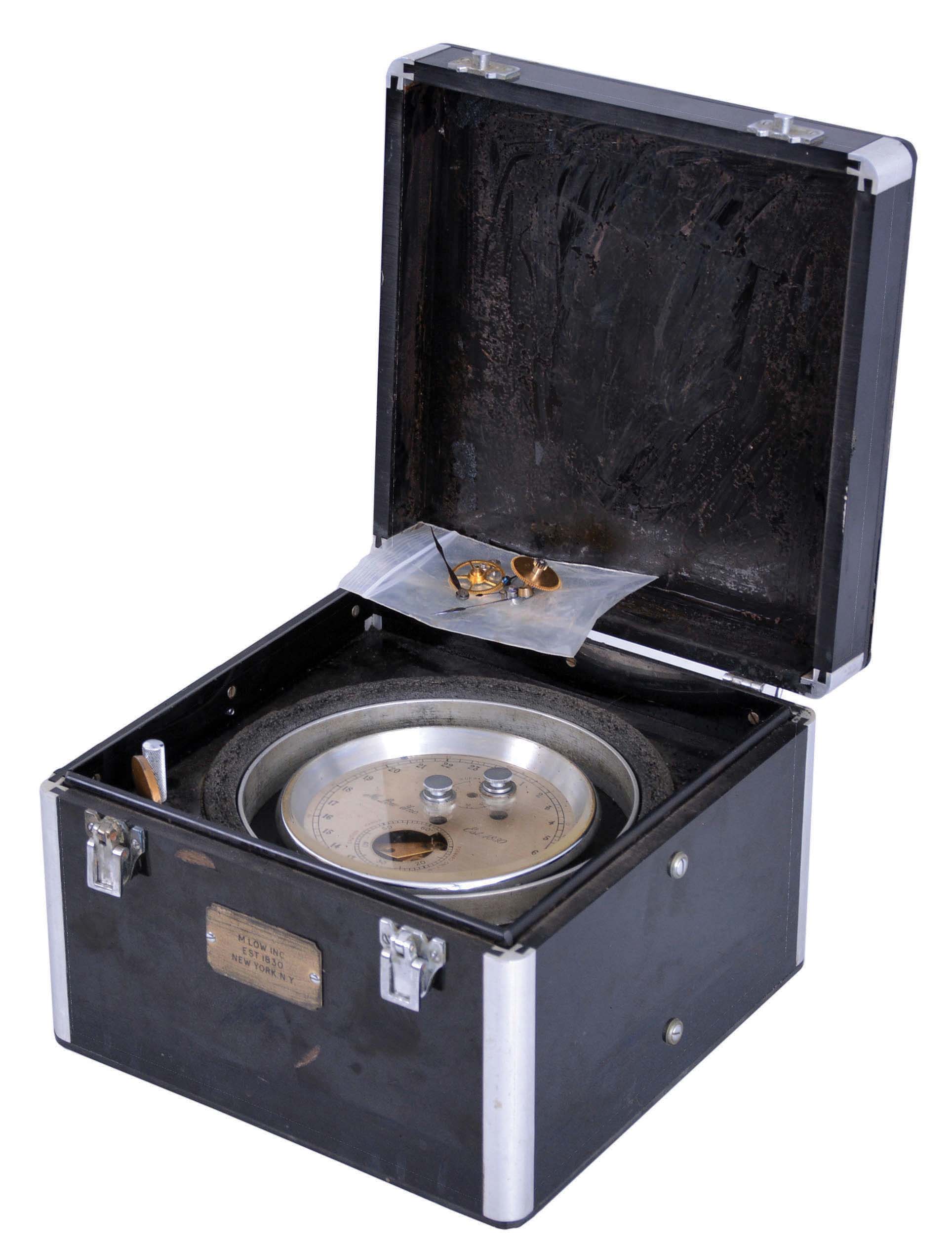 Thomas Mercer Ltd., St. Albans, England, for M. Low, Inc., New York, break circuit chronometer with mechanism for sending a signal at regular intervals, 13 jewel, two day fusee movement with Z balance, and spring detent escapement, an auxiliary wheel mounted to the the fourth wheel arbor closing a pair of contacts five times per minute at ten second intervals, and contained in an aluminum canister silvered 24 hour dial, blued steel hands, all contained in a black Bakelite box with aluminum corners, serial # 23506, mid 20th century — Antique Clocks Price Guide