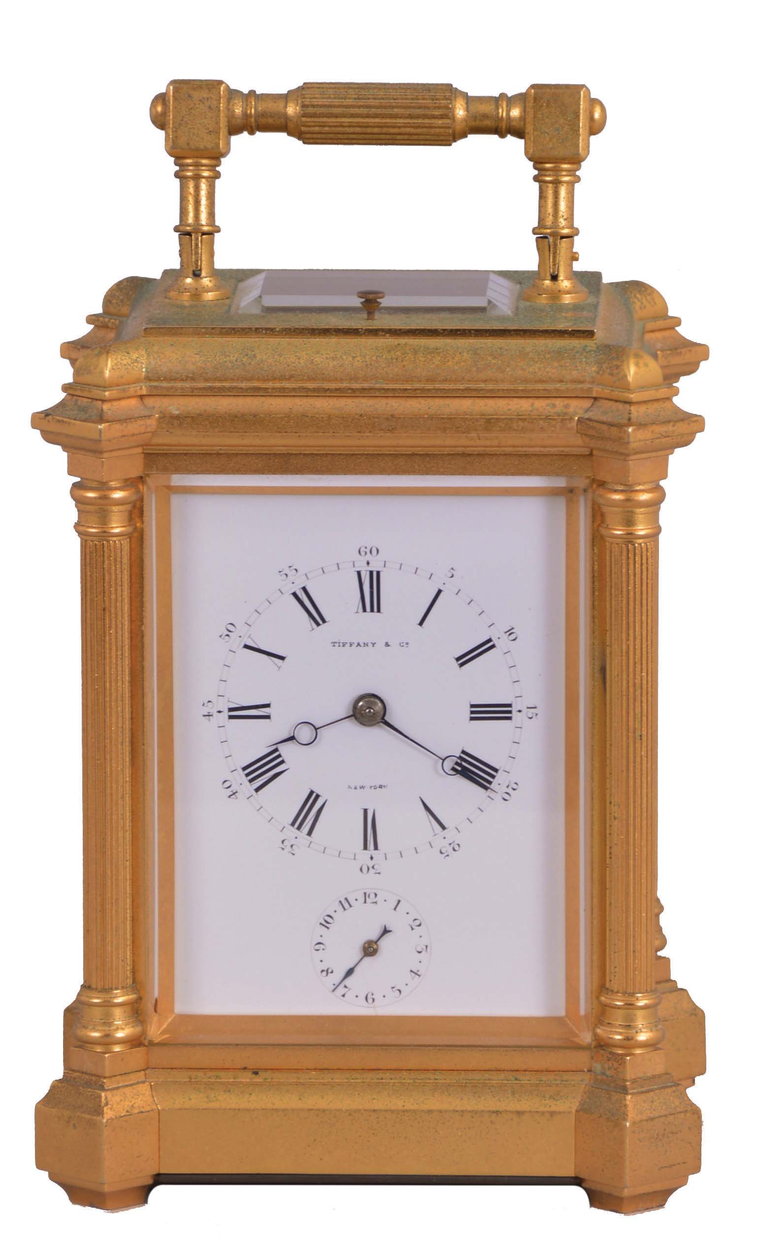 France, for Tiffany &amp; Co., New York, hour repeating carriage clock with alarm, the glazed, the gilt, architectural case with projecting corners, fluted columns supporting a molded cornice, and a conforming, ovolo molded top with carrying handle, Roman numeral white enamel dial with subsidiary alarm chapter, blued steel Breguet style hands, and 8 day, time and strike movement with lever platform, striking the hour and half hour in passing, and repeating the last hour on demand, serial #3130, dial and movement signed — Antique Clocks Price Guide