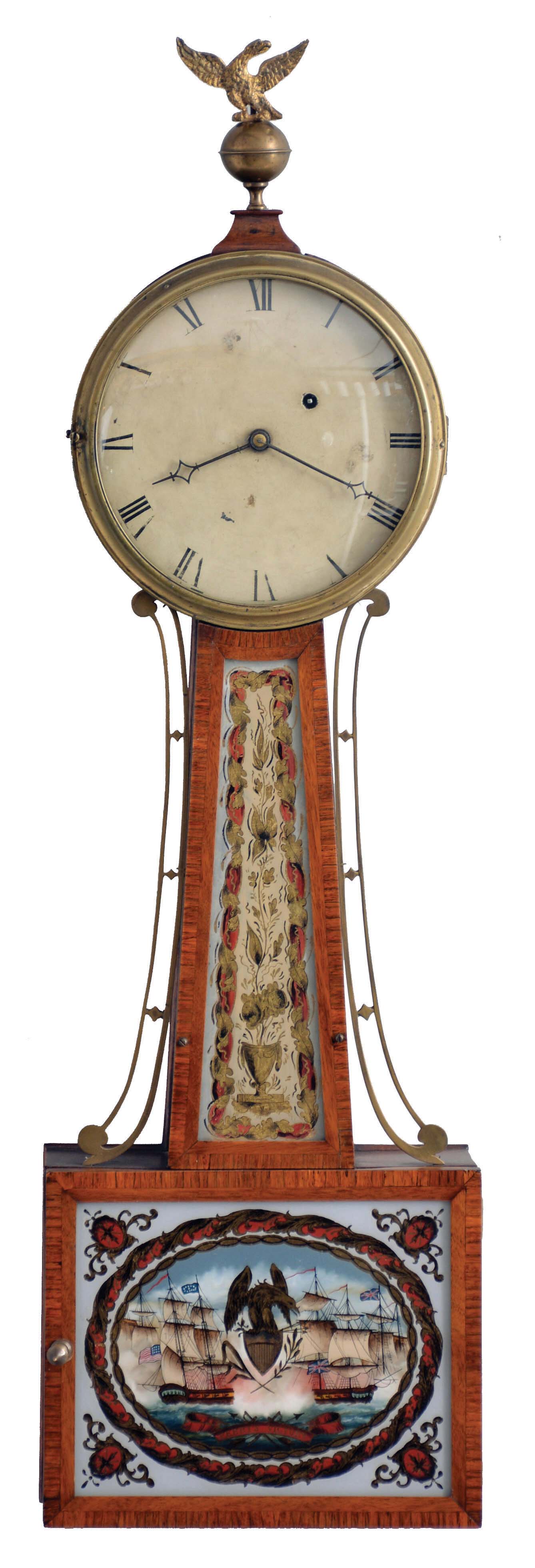 Boston area banjo clock, signed E. Taber, mahogany case, crossbanded door and throat frame with reverse painted glasses, cast bezel with convex glass, and top with ogee molded plinth and eagle finial, Roman numeral white painted dial with blued steel hands, 8 day timepiece movement with T bridge suspension and attached to case with diagonally opposed through bolts, blue painted weight baffle signed in script "Made by E. Taber Roxbury Jan 8 1815", wire pendulum rod with brass keystone and brass faced ball — Antique Clocks Price Guide