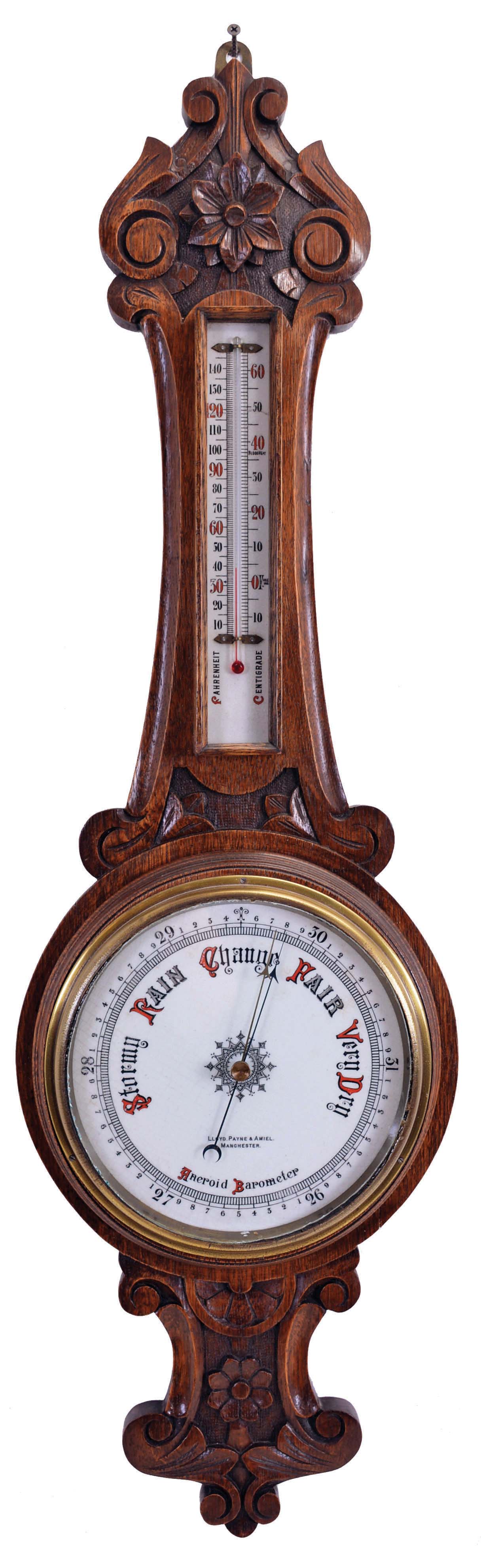 Barometers- 2 (Two) English: (1) Lloyd, Payne &amp; Amiel, Manchester, aneroid barometer with alcohol thermometer with red accented scales in a carved oak case with floral design; (2) Chapman, Lewes, banjo or wheel mercury barometer with thermometer, hygrometer, and spirit level in a rosewood veneered case. — Antique Clocks Price Guide