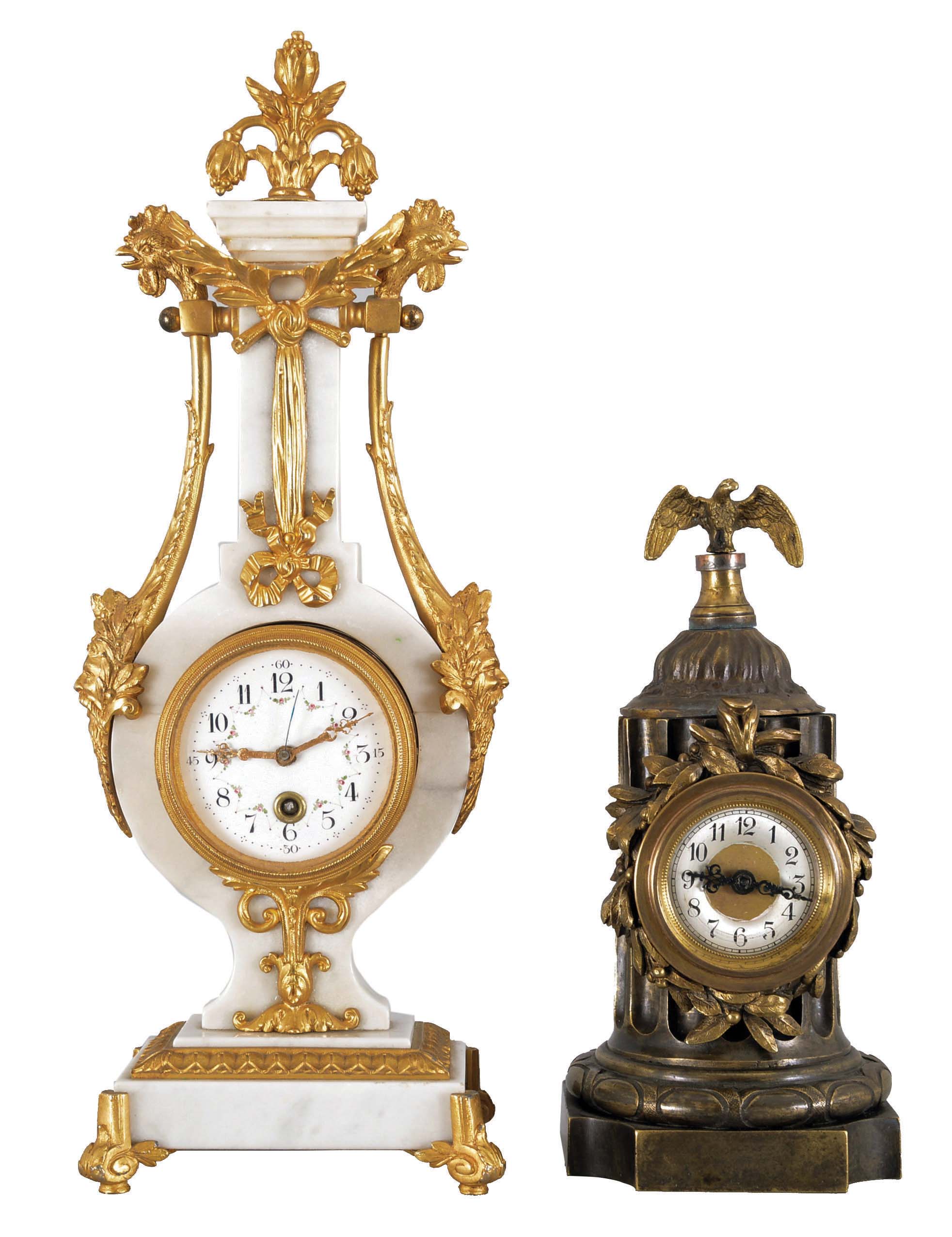 Clocks- 2 (Two) French: (1) Lyre form time only mantel clock, white marble with gilt brass mounts, male faces and rooster heads on opposite sides, the top with floral finial. White enamel dial with polychrome floral pattern and faux winding arbor; (2) Brass time only mantel clock in the form of a truncated fluted column, wreath bezel surrounding a silvered dial with Arabic numerals, supporting a small eagle with wings outstretched. — Antique Clocks Price Guide