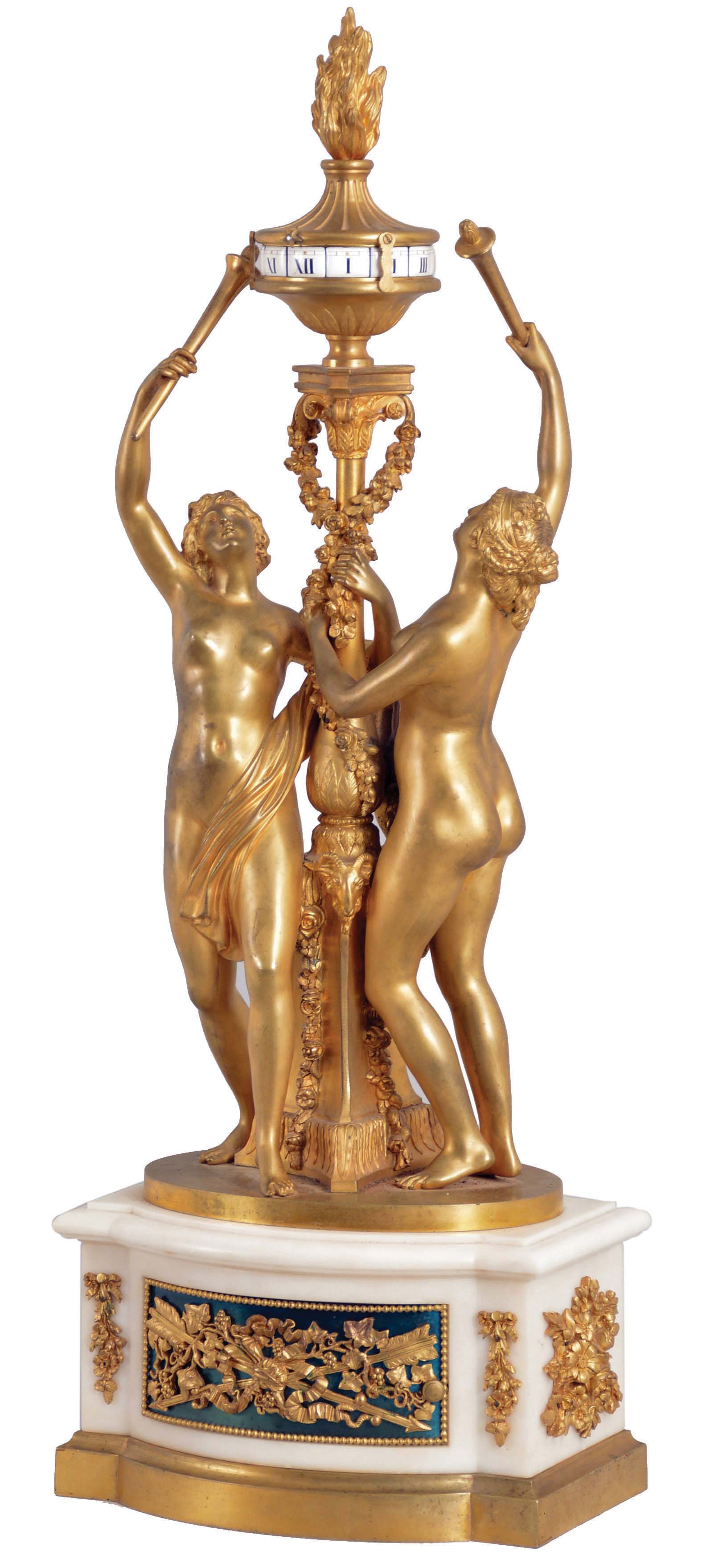 France, a large and impressive figural table clock with annular dial, the white marble base with bow front and back, each with a bead molded, blued steel door, mounted with gilt bronze ornaments, composed of a pair of crossed arrows with bowknot, and intermingled leaves and vines, the sides mounted with gilt floral arrangements, and resting on a conforming, cavetto molded plinth, surmounted by two female nudes flanking a central column with triangular base, and supporting an urn with flame finial containing the dial, each figure bearing a torch to "illuminate" the annular display, high quality 8 day timepiece movement with lever platform contained in the base, and linked to the dial through a rod in the column, front plate marked "AC" within an oval, and numbered 174 — Antique Clocks Price Guide
