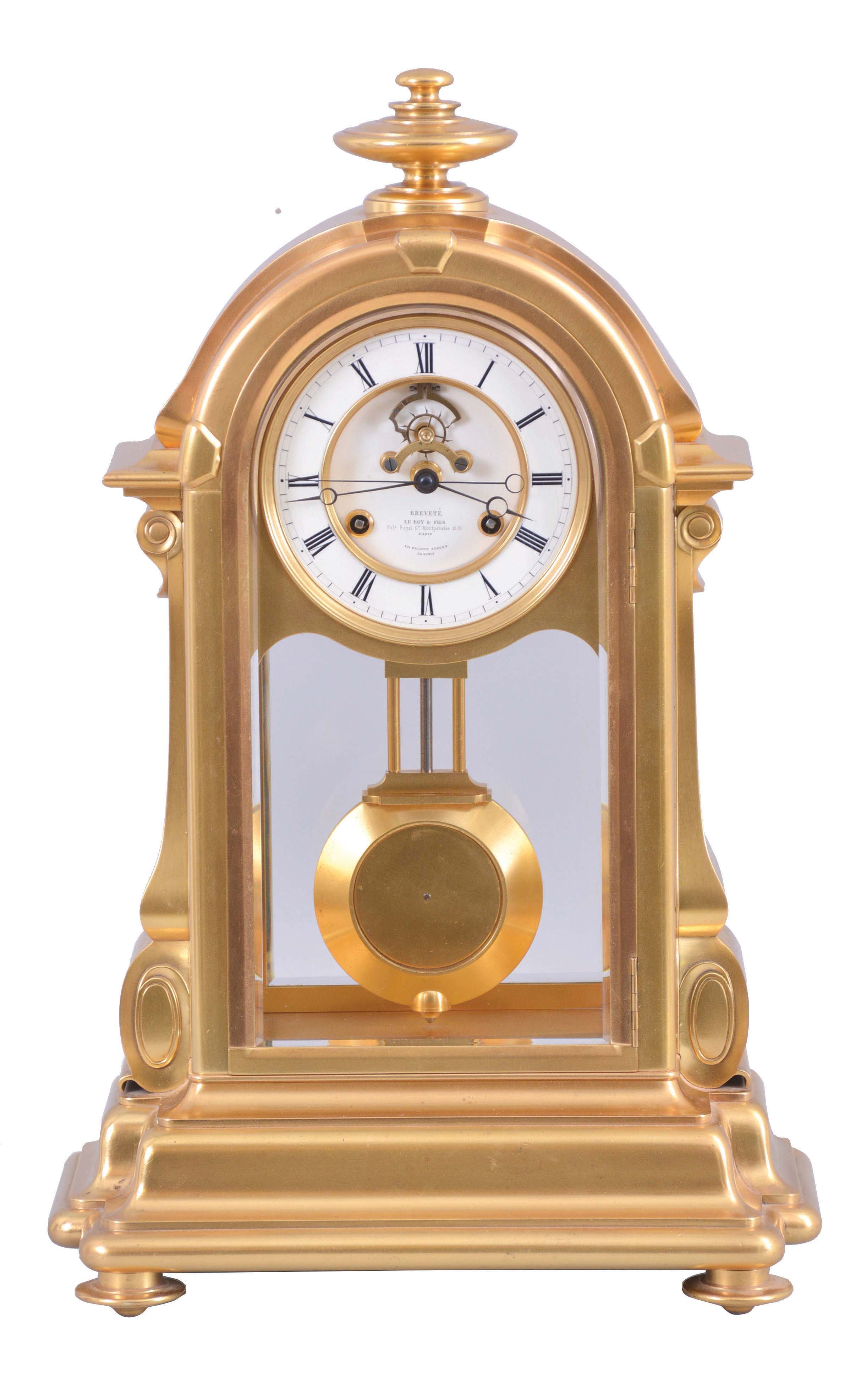 LeRoy &amp; Fils, Paris, for the English market, a large and unusual mantel or table regulator with coup perdu escapement and center seconds, in a glazed, gilt bronze case with arch top, the base with bold torus, ogee, and cavetto moldings, the sides with inverted, scrolled consoles below cavetto and ogee molded trim, and the top with turned finial, Roman numeral white enamel dial with recessed center, and visible escapement with jeweled pallets signed "Augte. Pointeaux", blued steel Breguet style hands, 8 day, time and strike movement by Pons with square plates, and with knob for setting at the upper left side of the back plate, gilt pendulum with heavy brass ball, dial and movement signed. — Antique Clocks Price Guide