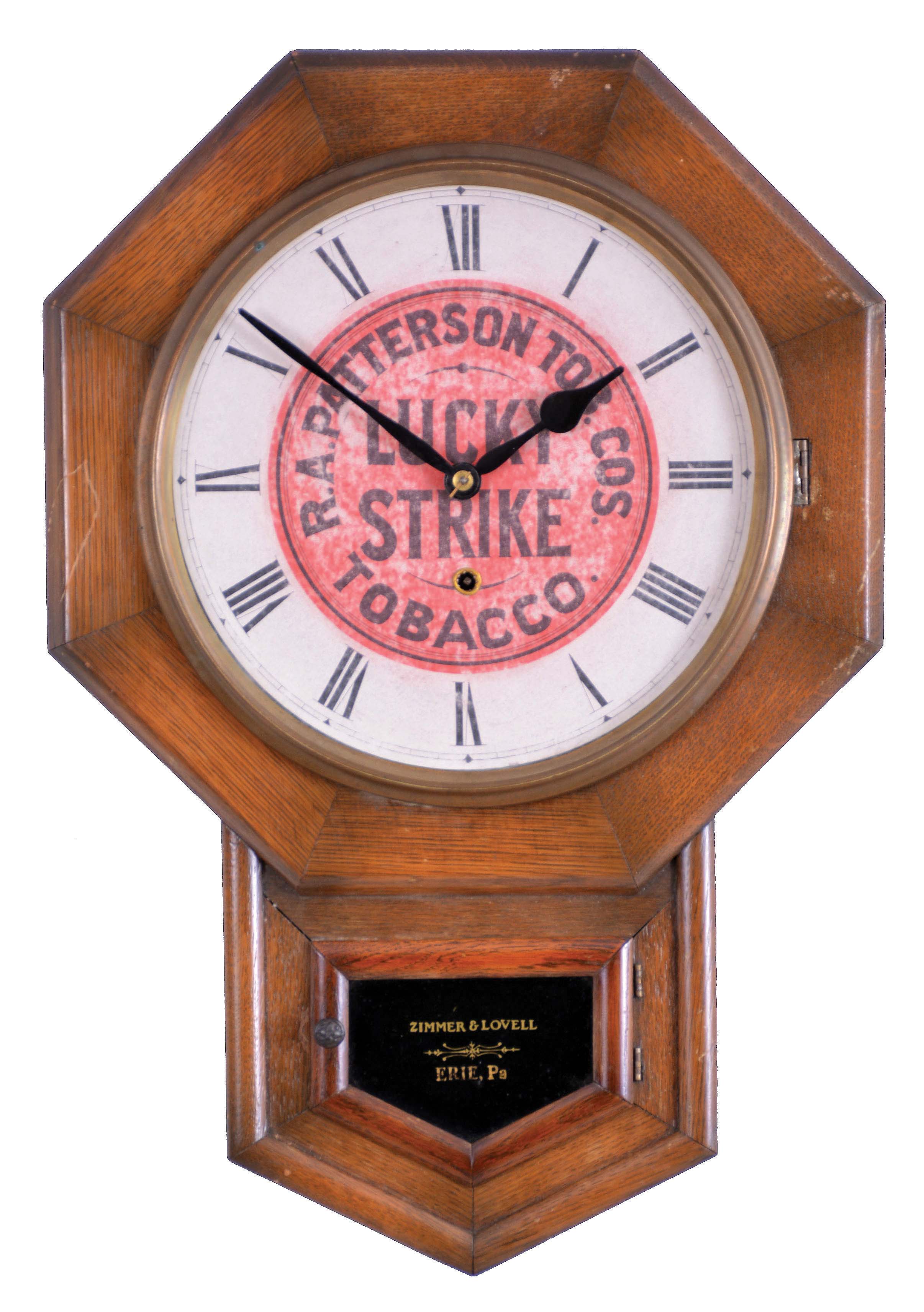 New Haven Clock Co., New Haven, Conn., "Drop Octagon" wall clock with Lucky Strike advertising, 8 day, time only, spring driven movement in an oak case with a tablet stenciled with retailer "Zimmer &amp; Lovell, Eerie, Pa" — Antique Clocks Price Guide