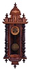 Clocks- 2 (Two): (1) an 8 day, time and strike, spring Vienna, hardwood case with turned ornament, Arabic numeral dial and brass pendulum; (2) a Gustav Becker "Freischwinger", walnut cased, with turned and carved ornaments, Arabic numeral square brass dial (uncommon) 8 day, time and strike movement