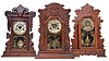 Clocks- 6 (Six) American Gingerbread in oak case, time and strike: (1) New Haven "Mayor" with alarm with patented removable top; (2) Gilbert with alarm and pendulum with regulator; (3) Waterbury with alarm with floral motif; (4) E. Ingraham "Dewey" model with eagle pendulum (partial) ; (5) Gilbert "Navy No. 28" with alarm; (6) Sessions in dark oak case