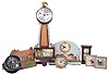 Clocks- 13 (Thirteen) Novelty including five Crusader wall clocks in the form of a coat of arms, two electric clocks, two animated Lux desk clocks, Deluxe Clock Co. New York "The Homestead", Seth Thomas Mark I wall clock and a Marlow & Co. miniature reproduction and an Ansonia alarm. J.E. Coleman states that the "Crusader" wall clock was made by the Vermont Clock Company. Though unsigned, these clocks did come from a collection in Vermont so may represent that model.