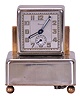 Renova, Switzerland, a nickel plated, musical alarm clockthe rectilinear case on ball feet, Arabic numeral metal dial, blued steel luminous baton hands, 30 hour timepiece movement with music box concealed in the base