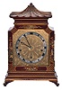 English, 8 day, time and strike spring driven, three train lever movement Westminster chime mantel clock in an Oriental-style gold and red Chinoiserie decorated case.