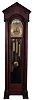 English, 3-train, 9-tube, brass dial tall clock, retailed by Bigelow, Kennard & Co., mahogany case with pediment top, door with two bevelled glasses, and with flanking columns having carved Ionic capitals, and resting on carved feet, composite dial with aplied numerals, silvered chapter ring and seconds bit, and displaying the phases of the moon, 8 day, quarter chiming, weight driven movemen