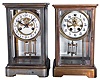 Clocks- 2 (Two) American crystal regulators: (1) William L. Gilbert Clock Co., Winsted, Conn. spring driven, 8 day, time and strike with visible escapement; (2) Unsigned, probably Waterbury Clock Co., Waterbury Conn., 8 day, time and strike, with a visible escapement.