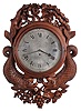 England, an ornately carved gallery timepiece, the mahogany case with turned bezel, surrounded with carved, foliate ornament, and with a pair of full bodied, facing dolphins below, Roman numeral silvered dial, 8 day, fusee timepiece movement