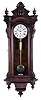 Seth Thomas Clock Co., Thomaston, Conn., "Regulator No. 5" wall clock, solid walnut and burl walnut veneered case, Roman numeral white enamel dial, blued steel spade hands, and weight driven timepiece movement, with maintaining power, brass clad, damascened pendulum, and brass clad weight with knurled caps