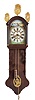 Holland, Staartklok, oak case with arch top bonnet, the door with half columns, gilt capitals and bases, and fancy stamped brass finials, the pendulum aperture with stamped brass ornament, arcaded, Roman numeral painted dial with polychrome landscape shoreline scene in the arch, and with applied, stamped brass figures at the corners, cast brass hands, thirty hour time and strike movement with alarm, tapered, copper clad weight